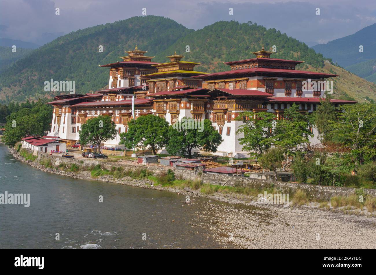 Scenic landscape view of ancient historic landmark Punakha dzong on bank of Mo Chhu river, Western Bhutan Stock Photo
