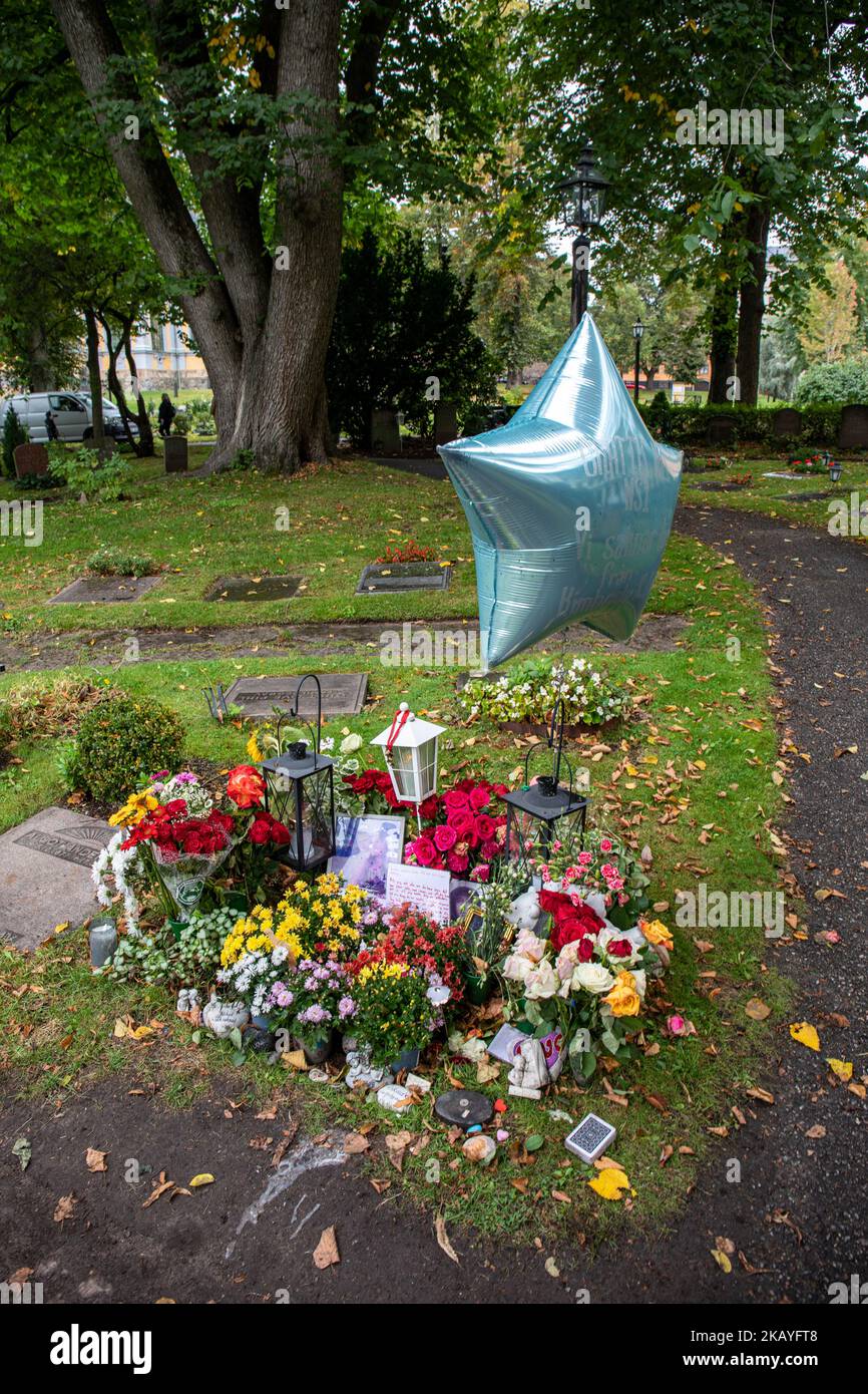 Flowers, pictures, letters and a balloon on the grave of Swedish rapper Einár in Katarina kyrkogård cemetery in Stockholm, Sweden Stock Photo