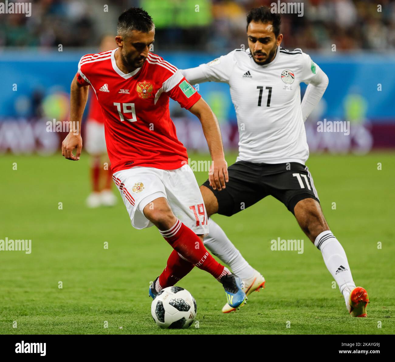Alexander Samedov (L) of Russia national team and Kahraba of Egypt national team vie for the ball during the 2018 FIFA World Cup Russia group A match between Russia and Egypt on June 19, 2018 at Saint Petersburg Stadium in Saint Petersburg, Russia. (Photo by Mike Kireev/NurPhoto) Stock Photo