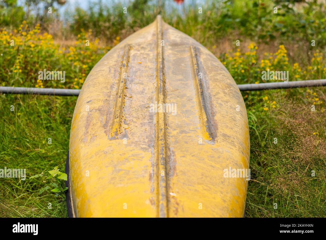 Yellow canoe lying upside down Stock Photo Alamy