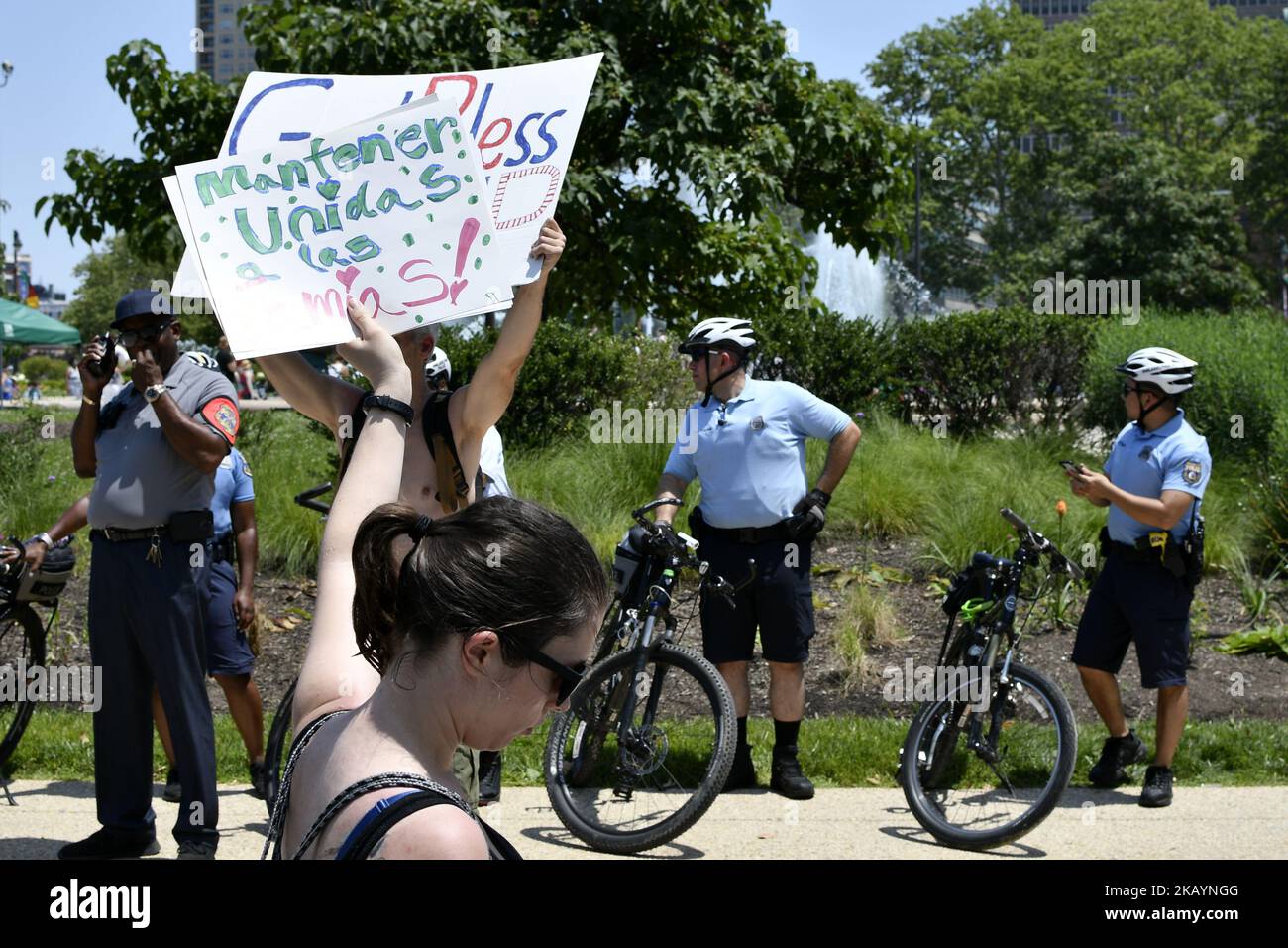 Protestors counter Howard Caplan, a local Trump supporter who holds a sign that reads God Bless Trump, as he stands, surrounded by Police officers, across a rally protesting Trump’s immigration policies, in Philadelphia, PA, on June 30, 2018. (Photo by Bastiaan Slabbers/NurPhoto) Stock Photo