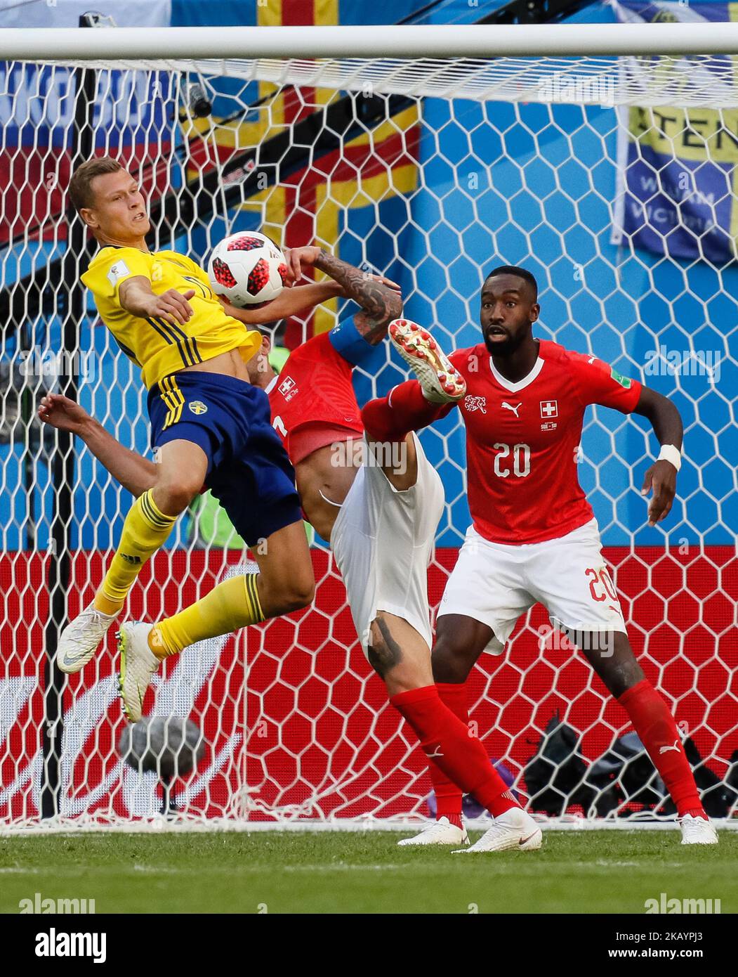 Viktor Claesson (L) of Sweden national team vies for the ball with Valon Behrami and Johan Djourou of Switzerland national team during the 2018 FIFA World Cup Russia Round of 16 match between Sweden and Switzerland on July 3, 2018 at Saint Petersburg Stadium in Saint Petersburg, Russia. (Photo by Mike Kireev/NurPhoto) Stock Photo