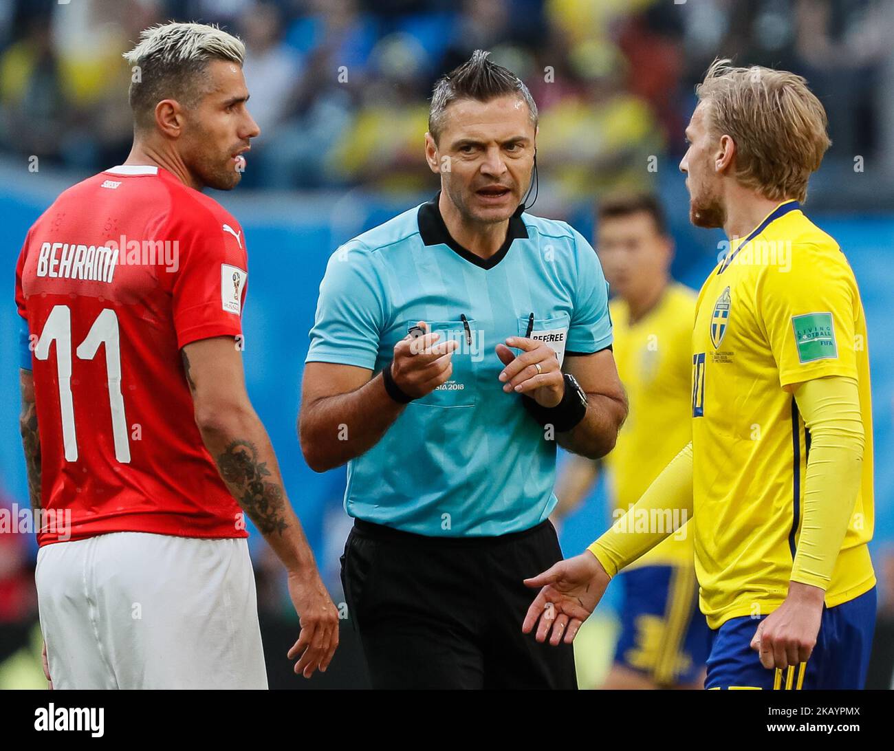 The referee Damir Skomina (C) talks to Emil Forsberg (R) of Sweden national team and Valon Behrami of Switzerland national team during the 2018 FIFA World Cup Russia Round of 16 match between Sweden and Switzerland on July 3, 2018 at Saint Petersburg Stadium in Saint Petersburg, Russia. (Photo by Mike Kireev/NurPhoto) Stock Photo