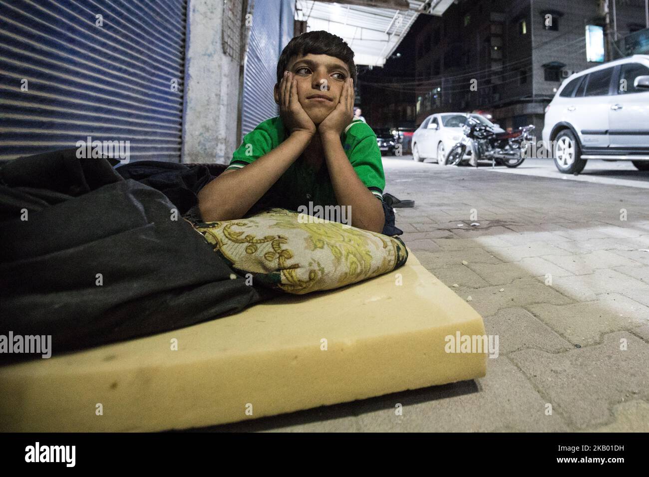 A homeless boy at his sleeping place on a street in Qamishli / Syria (Photo by Sebastian Backhaus/NurPhoto) Stock Photo