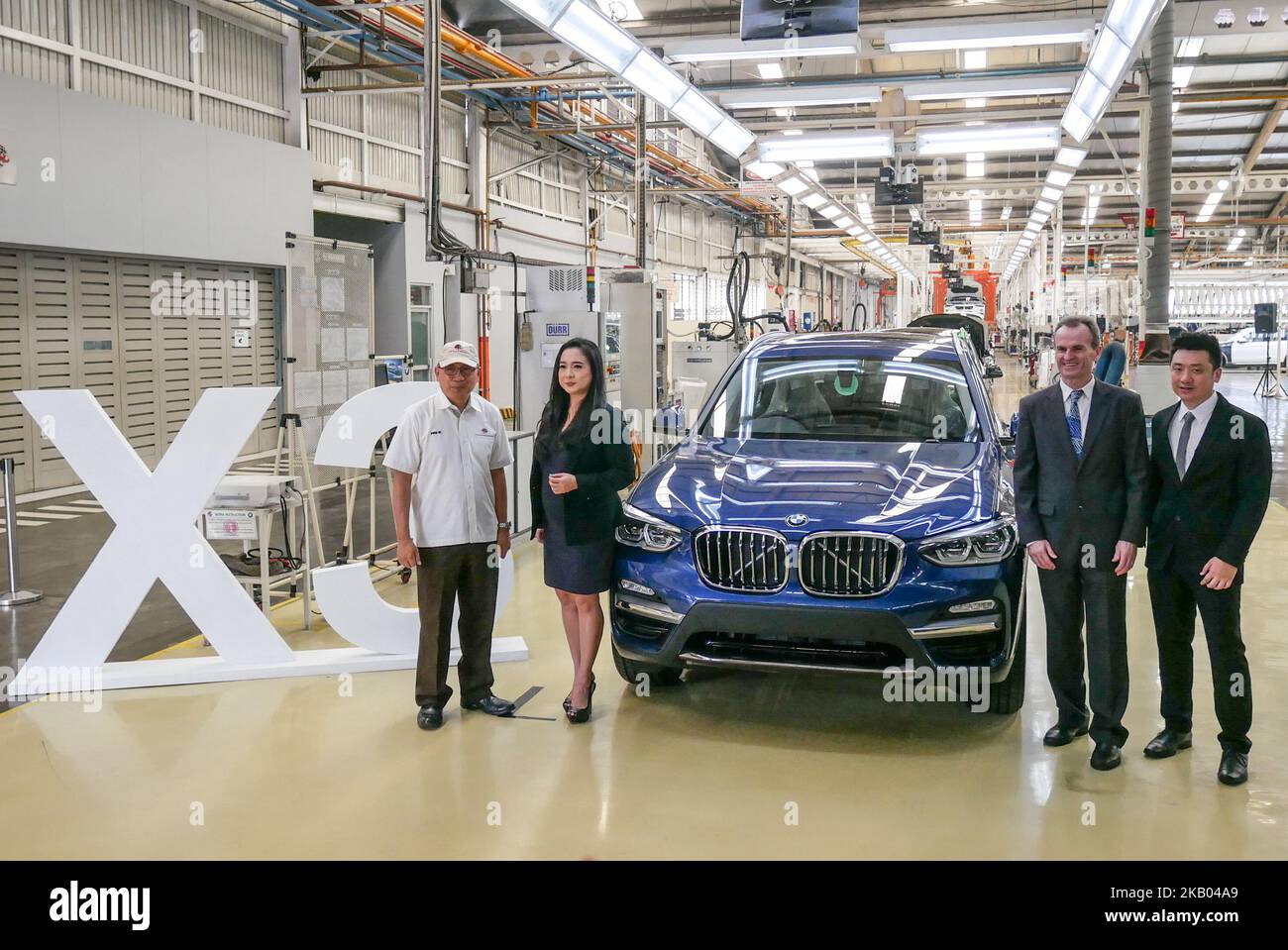 President Director PT Gaya Motor Ary Mariano, Vice-president communication BMW Indonesia Jodie O’tania and BMW Production Network Manager, Albert Reichl (L to R) pose with BMW X3 at PT Gaya Motor manufacture in Jakarta, Indonesia on July 18, 2018. BMW X3 is a sports activity vehicle assembly by PT Gaya Motor in Indonesia since 2012 and ready to sell on August 2018 for IDR 1.009.000.000. (Photo by Anton Raharjo/NurPhoto) Stock Photo