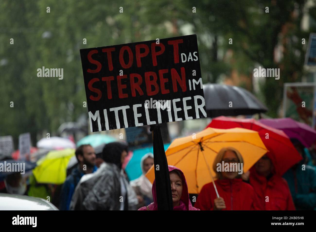 Protestor holds sign saying 'Stop the killing in the mediteranean'. Several ten thousands people demonstrated in Munich, Germany, on 22 July 2018 against the politics of the CSU party. There were different main topics such as Refugees and war, the Bavarian Polizeiaufgabengesetz (PAG), LGBTI, queer and women's rights, social issues such as housing and working rights. (Photo by Alexander Pohl/NurPhoto) Stock Photo