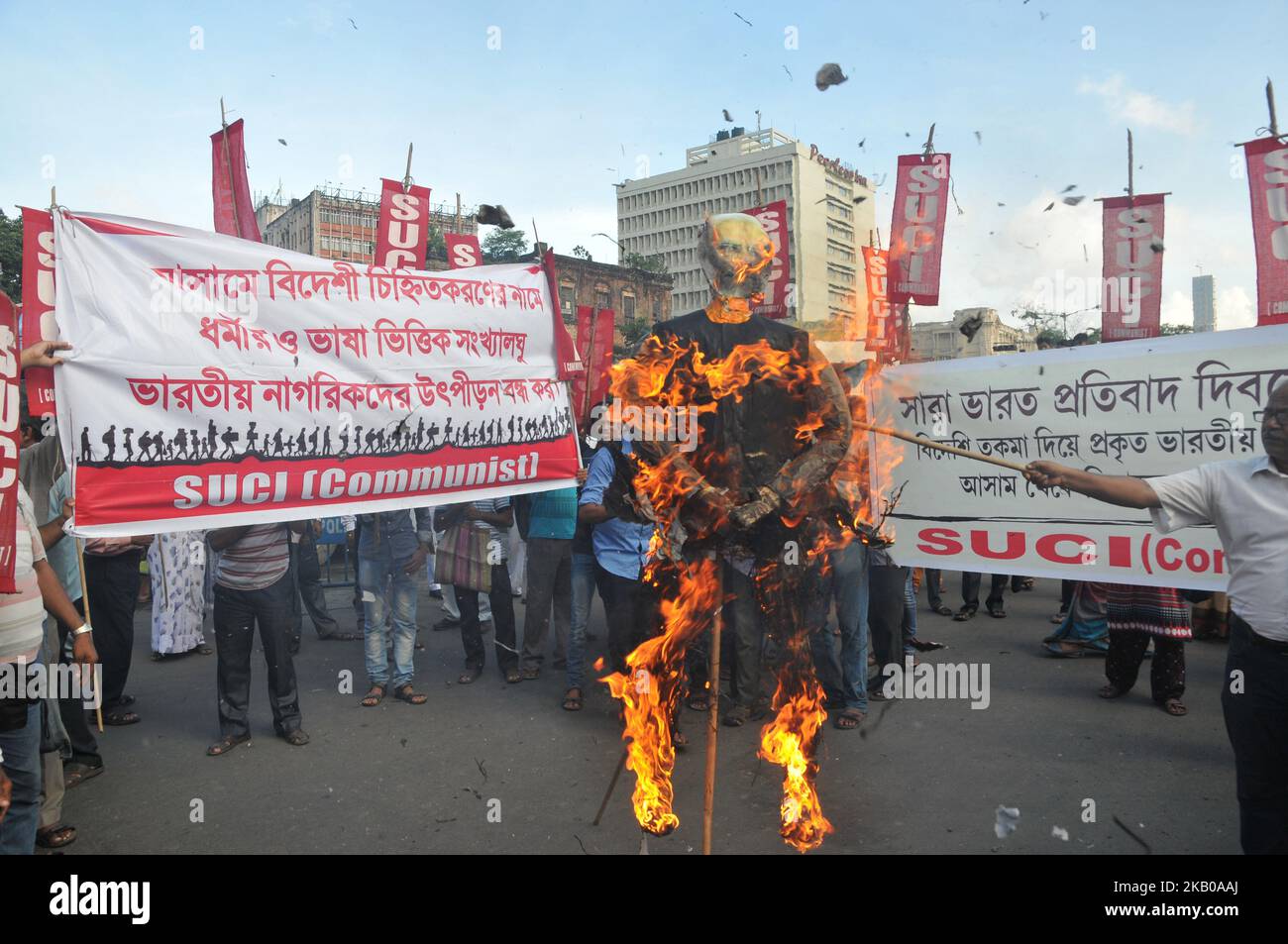 The Socialist Unity Centre of India (Communist) SUCI Political party activists hold posters and burn an effigy of Indian Prime Minister Narendra Modi during a protest following the publication of a draft of the National Register of Citizens (NRC) in Kolkata on August 08, 2018. India on July 30 stripped four million people of citizenship in the northeastern state of Assam, under a draft list that has sparked fears of deportation of largely Bengali-speaking Muslims. Critics say it is the latest move by right-wing Prime Minister Narendra Modi to advance the rights of India's Hindu majority at the Stock Photo