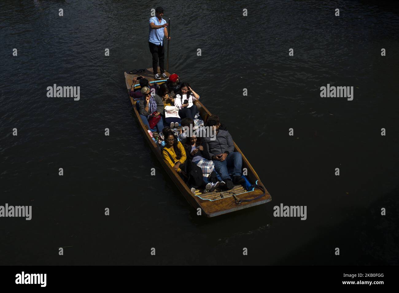 Boats on the river Cam are pictured in Cambridge, on August 25, 2018. Cambridge is home to the world-renowned University of Cambridge, which was founded in 1209. The university includes King's College Chapel, Cavendish Laboratory, and the Cambridge University Library, one of the largest legal deposit libraries in the world. The city's skyline is dominated by several college buildings, along with the spire of the Our Lady and the English Martyrs Church, the chimney of Addenbrooke's Hospital and St John's College Chapel tower. Anglia Ruskin University, evolved from the Cambridge School of Art an Stock Photo