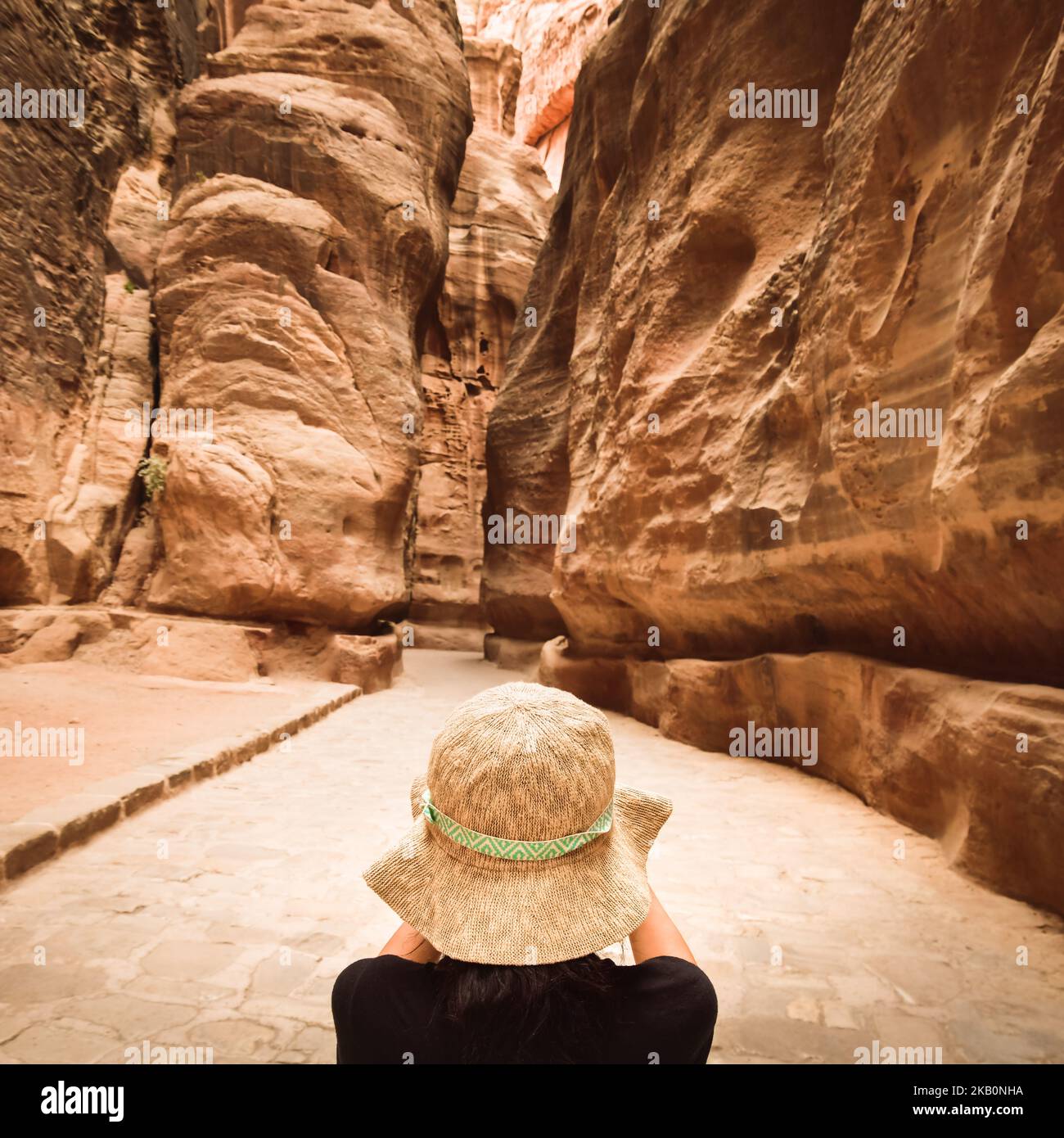 Tourist in Petra take photograph of The Siq, the narrow slot-canyon that serves as the entrance passage to the hidden city of Petra, Jordan Stock Photo