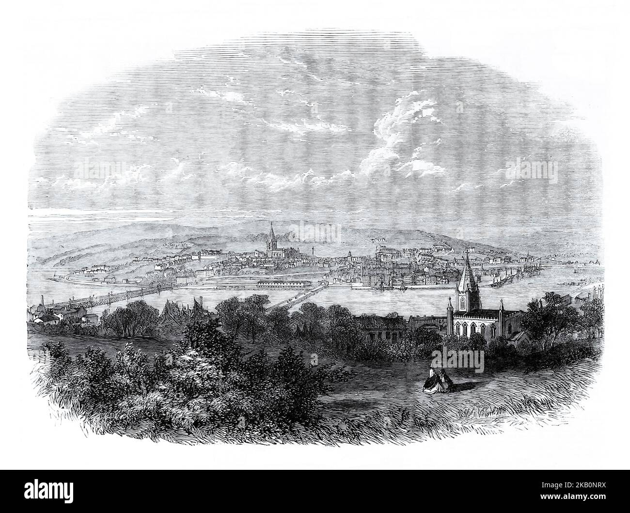A 19th century view of Derry (aka Londonderry) city from the east bank of the River Foyle. It was rebuilt in the 18th century with many fine Georgian houses. The city's first bridge across the River Foyle was built in 1790. During the 18th and 19th centuries the port became an important embarkation point for Irish emigrants setting out for North America. Stock Photo