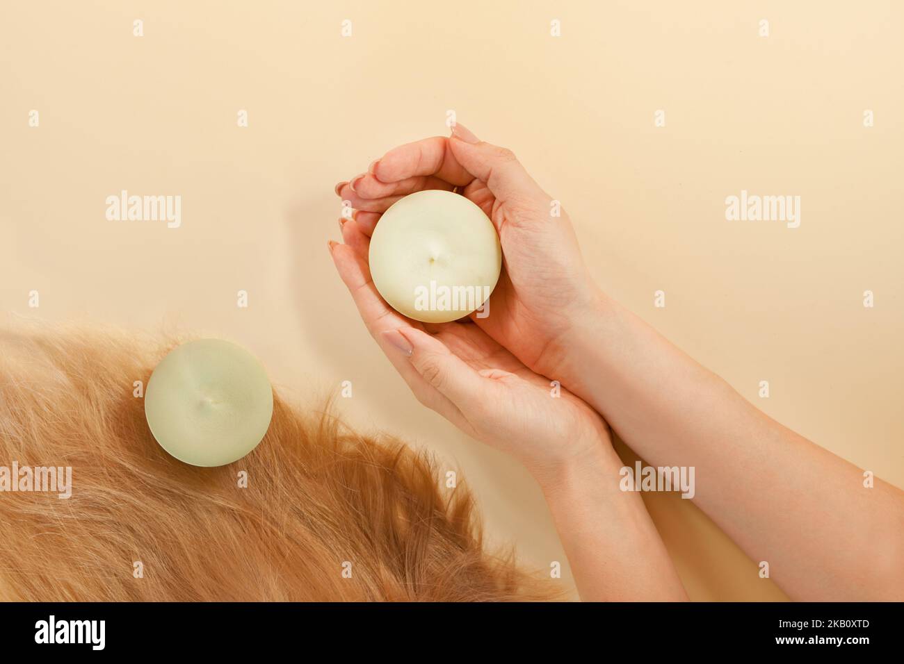 solid shampoo on womans hands- eco - hair care organic Spa treatement-zero waist Stock Photo