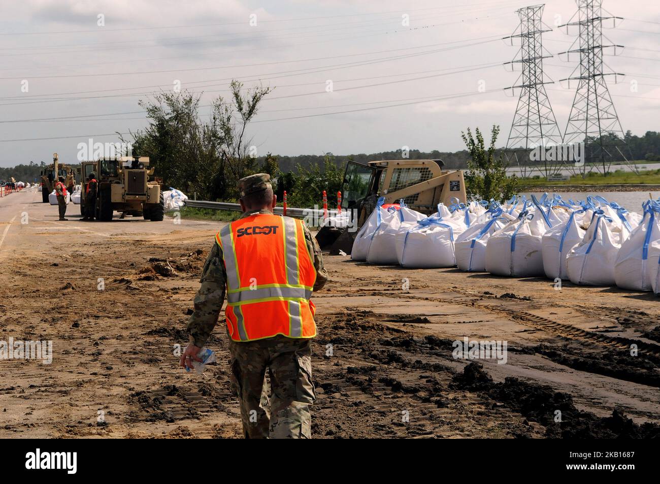 Conway, South Carolina, United States - Members of the South Carolina National Guard build a sandbag barrier on highway 501 along Lake Busbee in Conway, South Carolina on September 17, 2018, after the passing of Hurricane Florence. The City of Conway halted its previous efforts to stop the construction of the sandbag dam after being assured by state and county officials on September 17 the barrier would not cause additional flooding into Conway. (Photo by Paul Hennessy/NurPhoto) Stock Photo