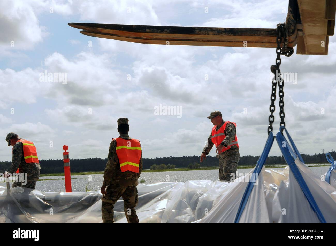 Conway, South Carolina, United States - Members of the South Carolina National Guard build a sandbag barrier on highway 501 along Lake Busbee in Conway, South Carolina on September 17, 2018, after the passing of Hurricane Florence. The City of Conway halted its previous efforts to stop the construction of the sandbag dam after being assured by state and county officials on September 17 the barrier would not cause additional flooding into Conway. (Photo by Paul Hennessy/NurPhoto) Stock Photo