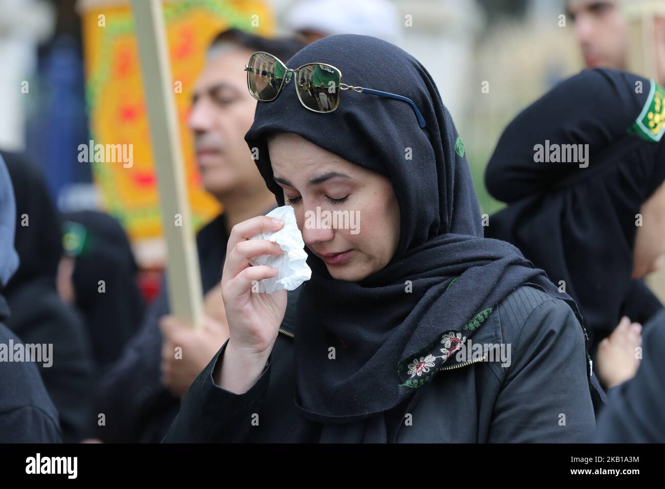 Woman crying as Shiite Muslim mourners take part in a Muharram procession in Toronto, Ontario, Canada, on September 20, 2018. Hundreds of Shiite Muslims took to the streets to commemorate the death of the third Imam, Hussein, slain along with 72 of his comrades in a battle against the army of the seventh-century caliph Yazid. In keeping with the military nature of these Ashura processions, mourners simulate self-flagellation and pound on their chests to the thump of a bass drum and the crackle of a snare. (Photo by Creative Touch Imaging Ltd./NurPhoto) Stock Photo
