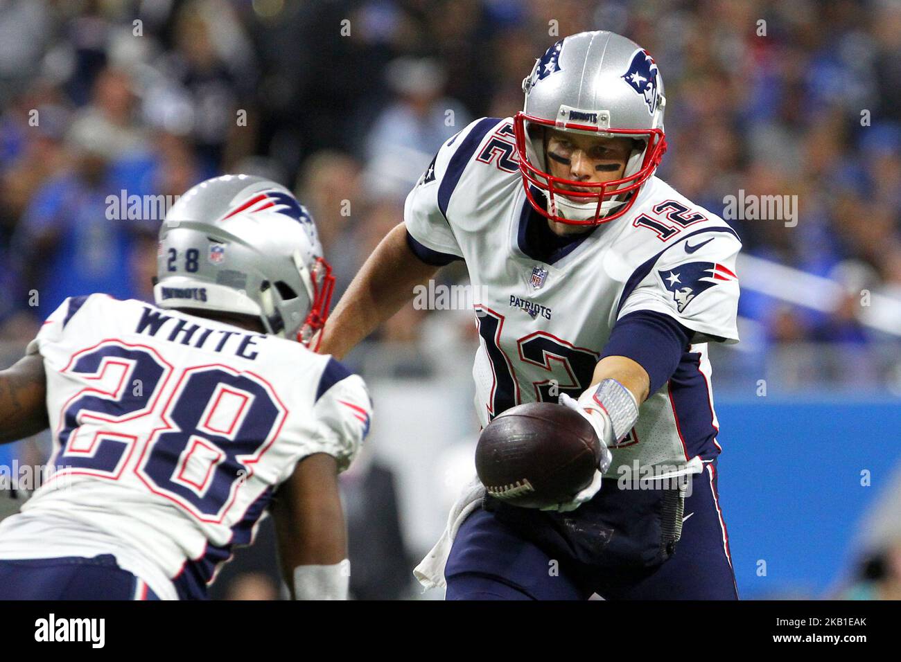 New England Patriots quarterback Tom Brady #12 prepares to hand off the ball to New England Patriots running back James White #28 during the first half of an NFL football game against the Detroit Lions in Detroit, Michigan USA, on Sunday, September 23, 2018. (Photo by Amy Lemus/NurPhoto) Stock Photo