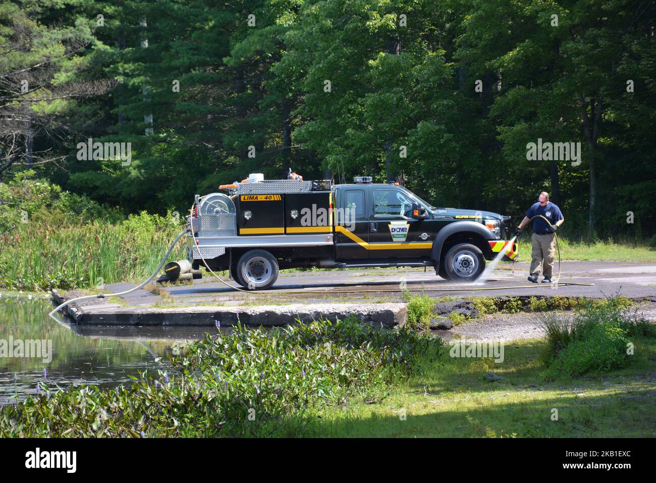 Employee of PA.bureau of Forestry DCNR Wildfire Control, washes a DCNR