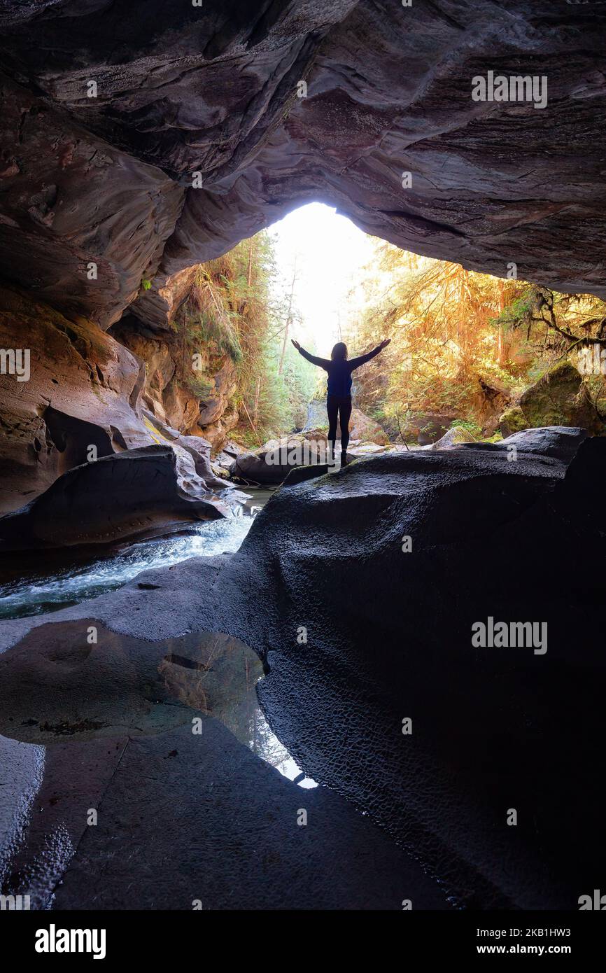 Adventurous woman standing inside a cave. Adventure Travel. Little Huson Caves Park Stock Photo