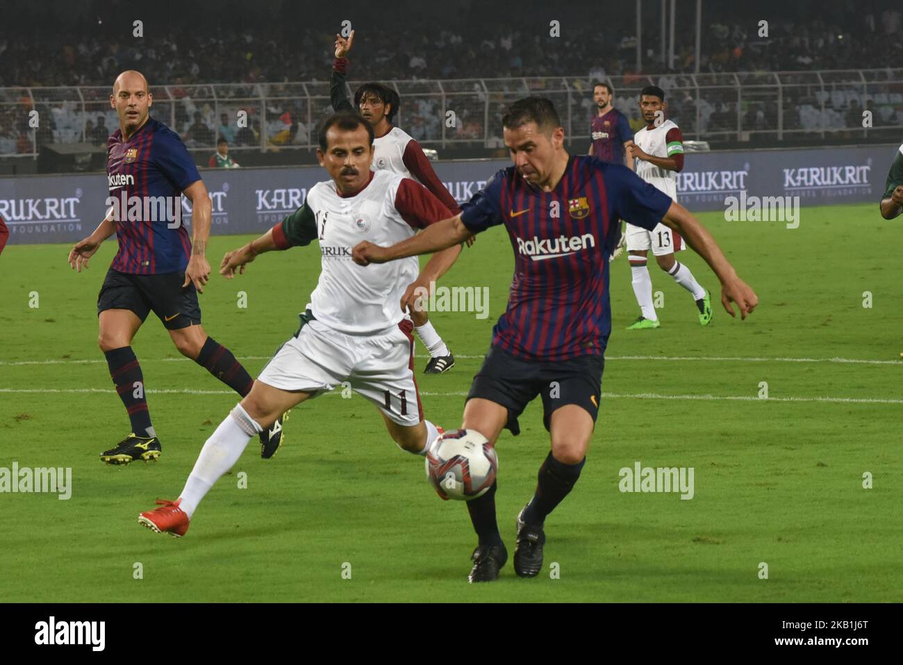 FC Barcelona legends player Javier Saviola (C) fights for the ball against players of FC legends and Mohun Bagan AC during an exhibition match between FC Barcelona legends and Mohun Bagan AC legends at the Yuva Bharati Krirangan stadium in Kolkata on September 28, 2018. FC Barcelona 6 Goal and Mohanbagan - 0. (Photo by Debajyoti Chakraborty/NurPhoto) Stock Photo