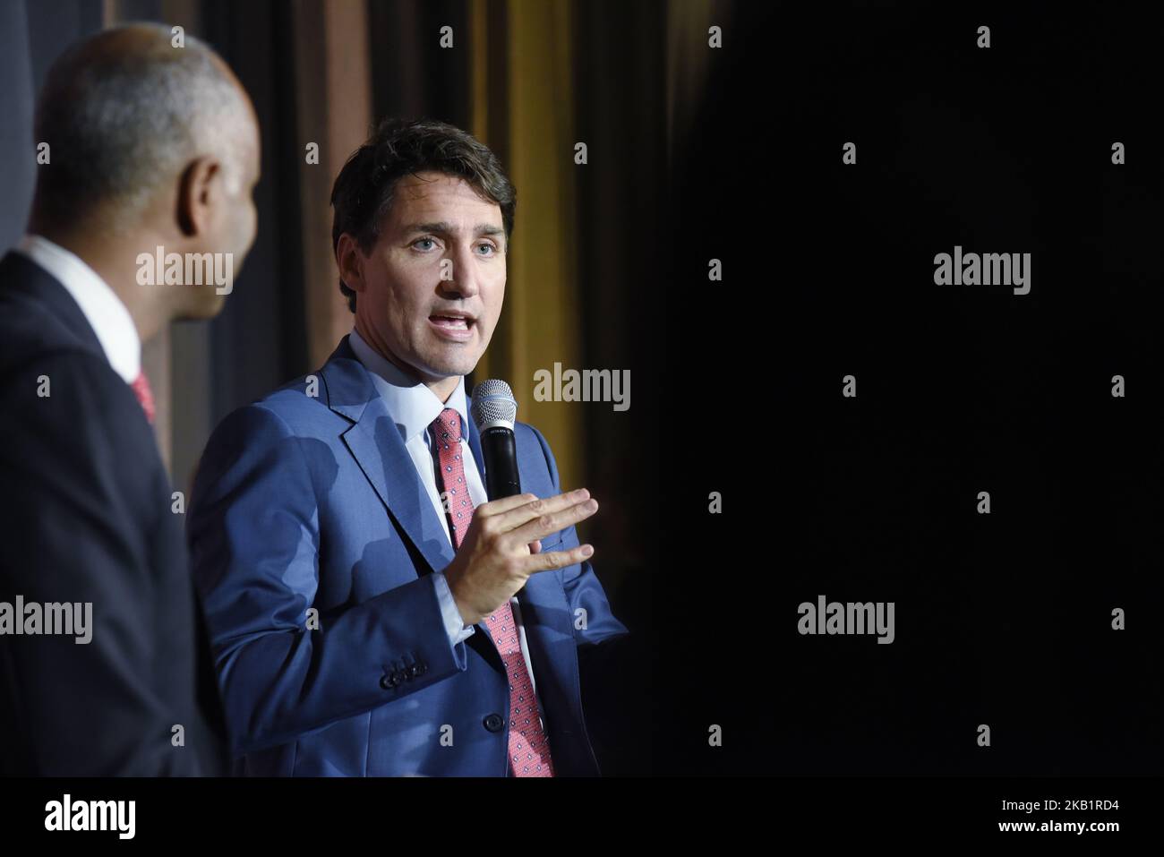 Prime Minister Justin Trudeau speaking while Ahmed Hussen the Minister of Immigration, Refugees