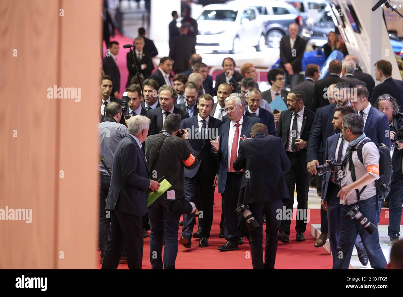 French President Emmanuel Macron (C) flanked by head of French auto industry lobby PFA Luc Chatel (L) speaks with CEO of France-based multinational automotive supplier Valeo Jacques Aschenbroich (R) during an official visit at the Paris auto show in Paris, France on October 3, 2018. From October 4 - October 14, the famous motor show will showcase new cars and products from major motoring manufacturers. (Photo by Michel Stoupak/NurPhoto) Stock Photo