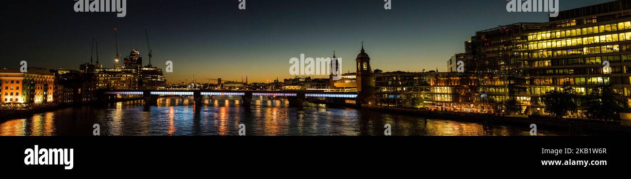 Panoramic view looking west down the River Thames at night time, London England Stock Photo
