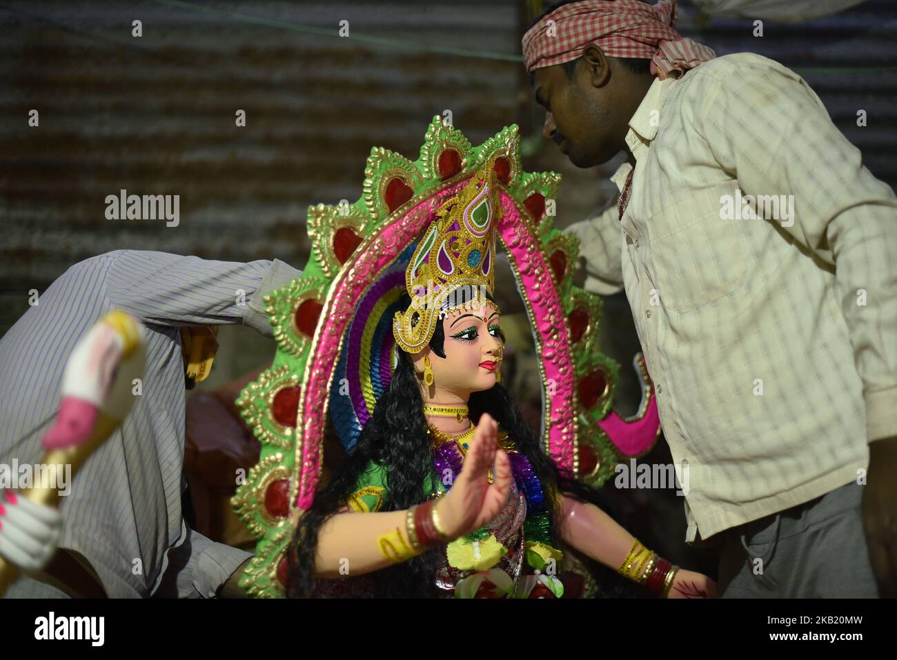 Workers arranging the Hindu Goddess Durga, which is being transported