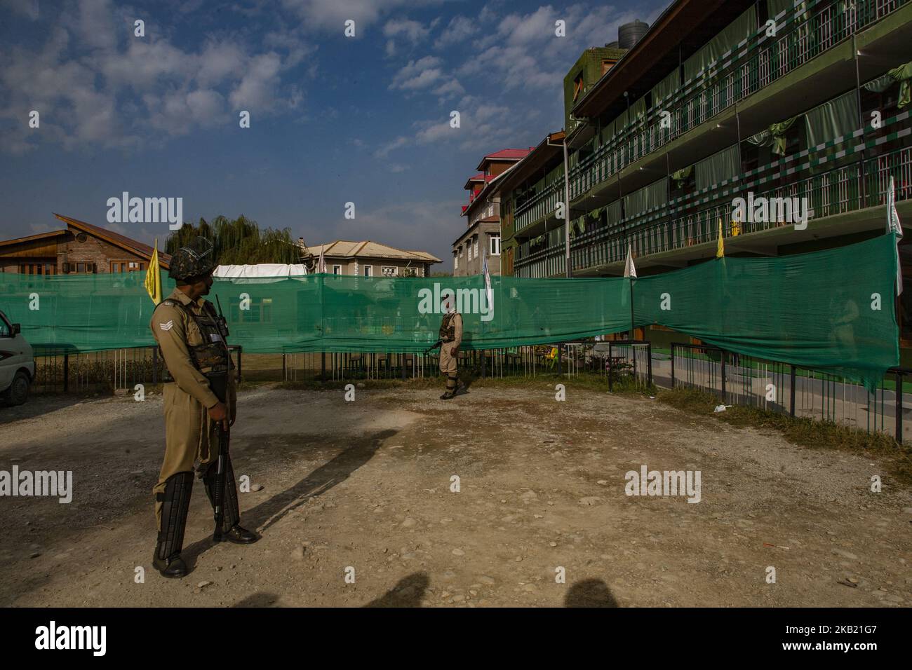 Indian government forces guard a deserted polling station, during the second phase of municipal polls, on October 10, 2018 in Srinagar, the summer capital of Indian administered Kashmir, India. Poor voter turnout marked the second phase of municipal elections in Kashmir amid a partial shutdown and heavy deployment of government forces across the region. Pro-independence groups have rejected the polls as farce and called for a boycott while major pro-India parties like National Conference and Peoples Democratic Party (PDP) also stayed away from the electoral process alleging Indian governments  Stock Photo