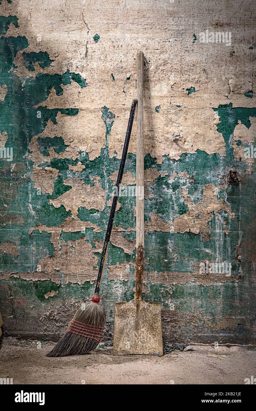 Old dirty broom and shovel Stock Photo