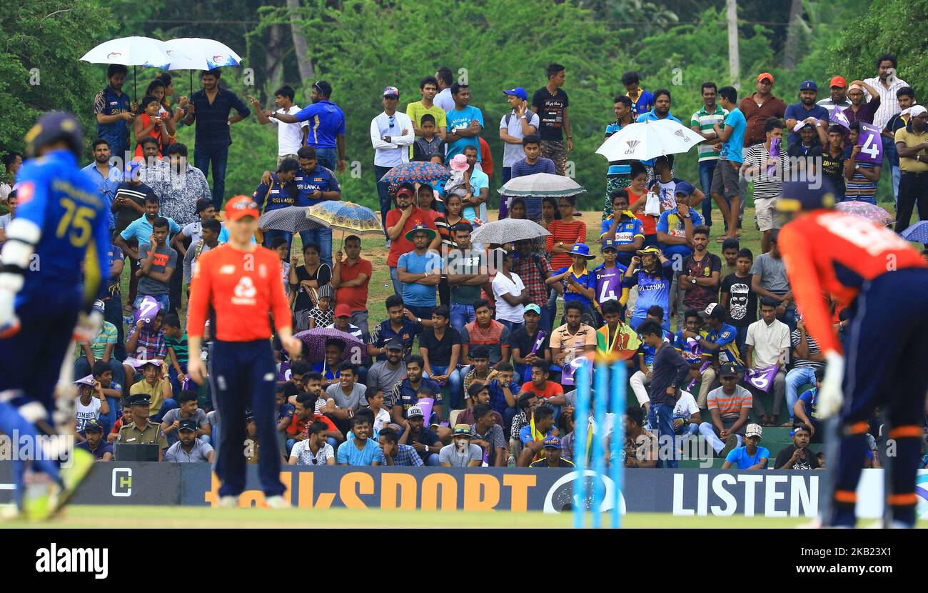 Sri Lankan fans watch the cricket match amid rain during the 2nd One Day Inallternational cricket match between Sri Lanka and England at the Rangiri Dambulla International Stadium, Dambulla, Sri Lanka. Saturday 13 October 2018 (Photo by Tharaka Basnayaka/NurPhoto) Stock Photo