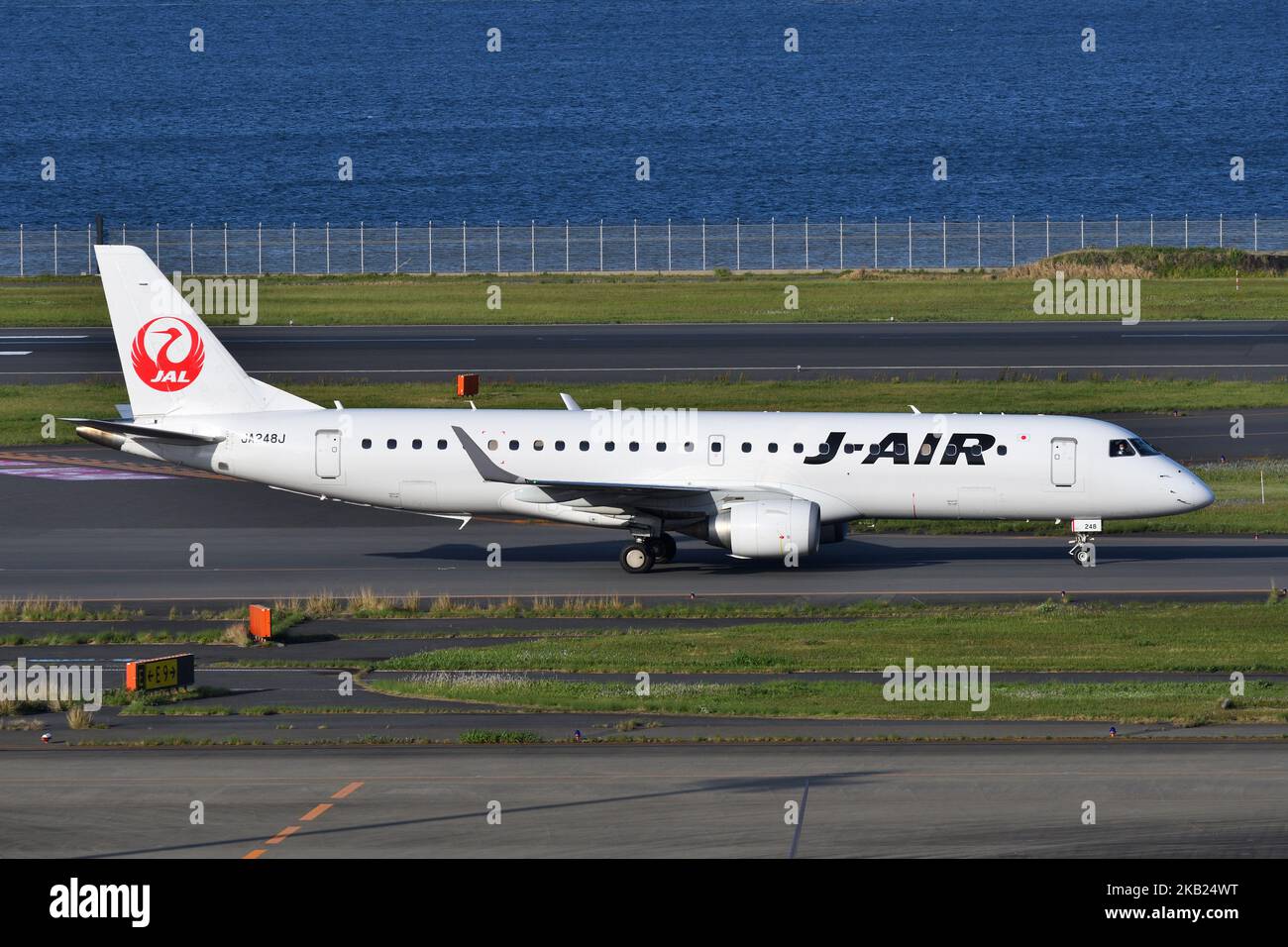 Tokyo, Japan - April 18, 2021: J-Air Embraer E190STD (JA248J) passenger plane taxiing at Tokyo International Airport. Stock Photo
