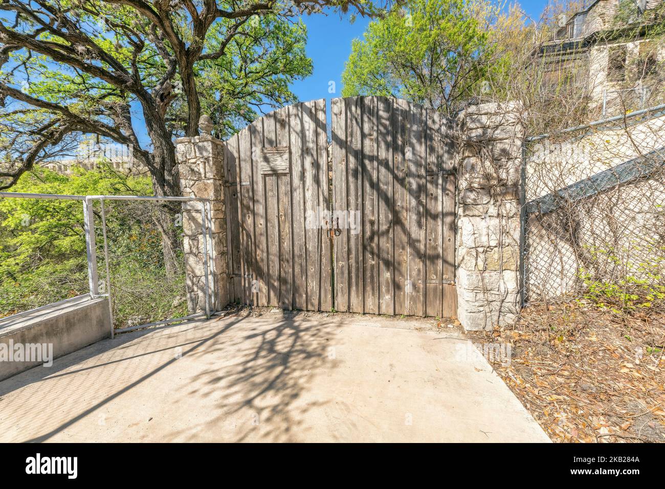 Old wooden gate with stone posts at the entrance of a property in