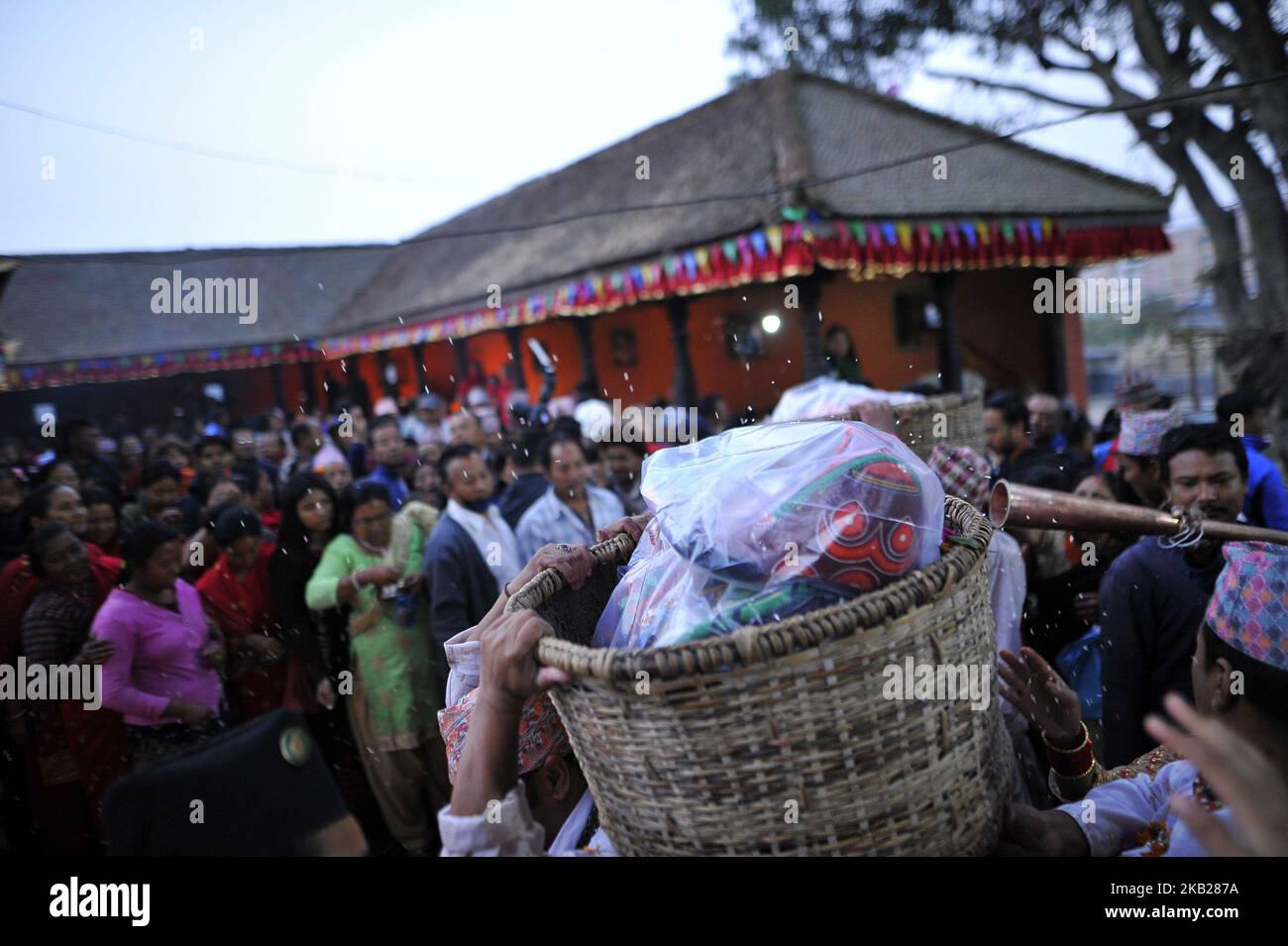 Nepalese Hindu priests carrying ritual mask of deity during the tenth