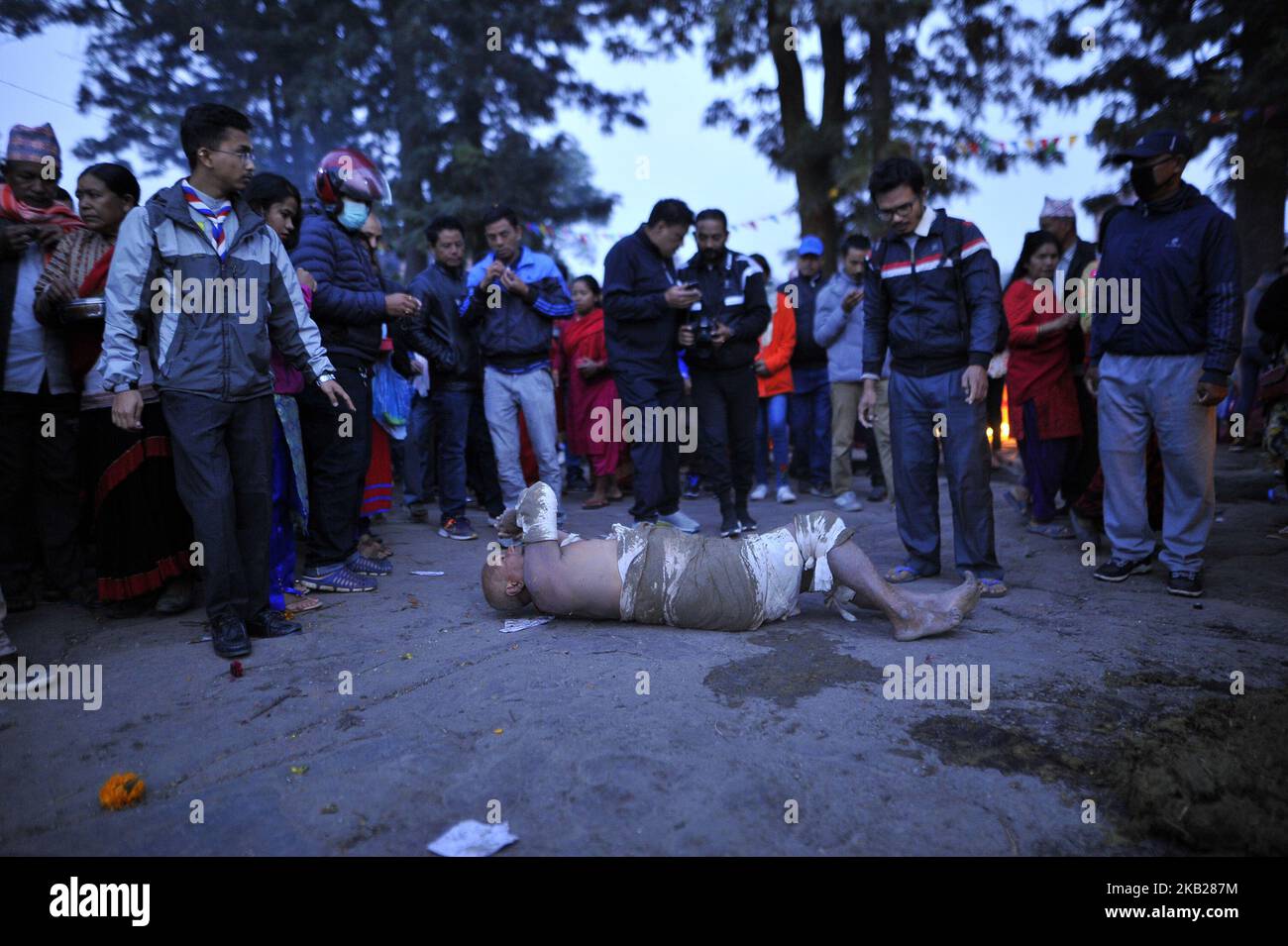 A Nepalese devotee roll on a ground to offer ritual prayer during the