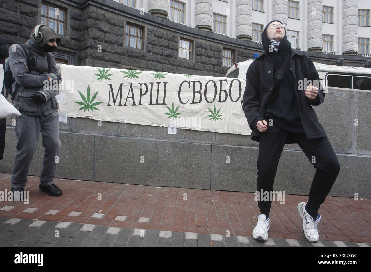 Ukrainian activists dance during a rally for legalization of using of marijuana, near the Cabinet of Ministers, in Kiev,Ukraine, 27 October, 2018. A group of activists gathered to demand Ukrainian officials decriminalization and the legalization of the use of marijuana. (Photo by NurPhoto) Stock Photo