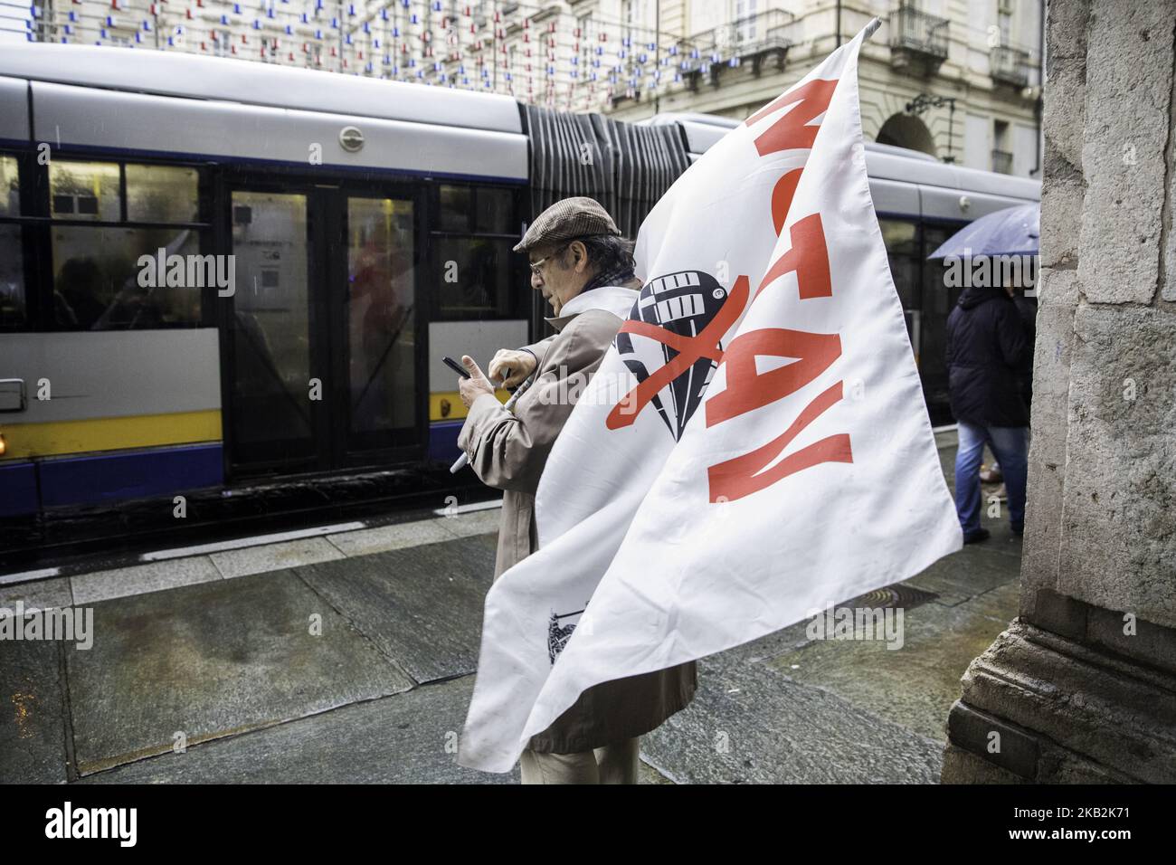 29/10/2018, Torino Italy. In the day where the town council voted to stop the project of the high speed train two different party meet in front of city hall, one against high speed train and one favorable at the construction of the new railway that will connect Torino with Lyon in France. In the picture a man with a No Tav flag. (Photo by Mauro Ujetto/NurPhoto)  Stock Photo