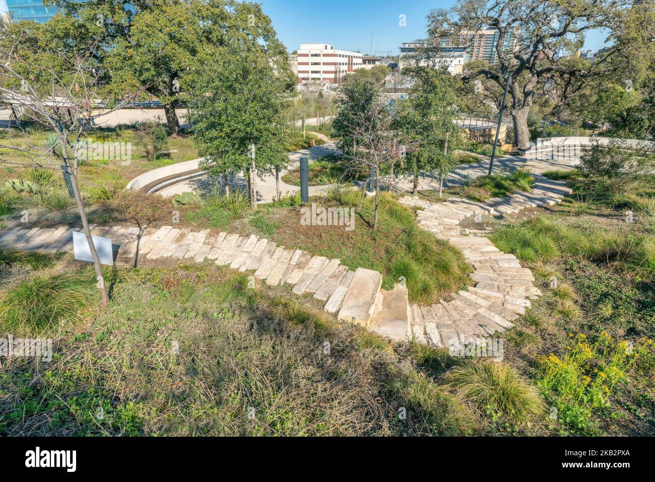Stone brick walking trail on grassy land at Waterloo Park in Austin Texas Stock Photo