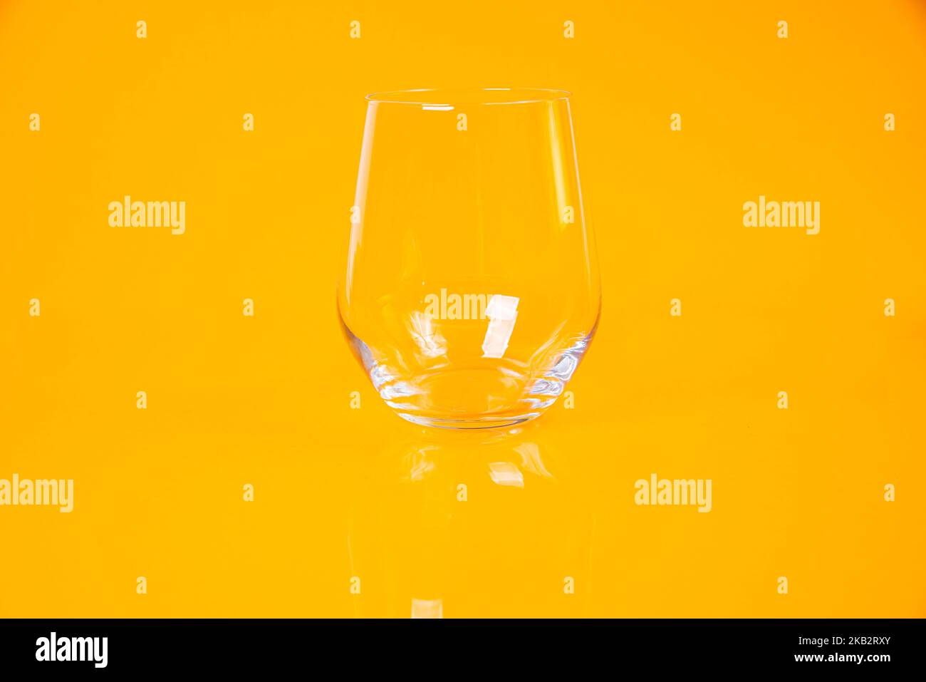 empty glass empty jar empty ice bucket on orange background top front view isolated Stock Photo
