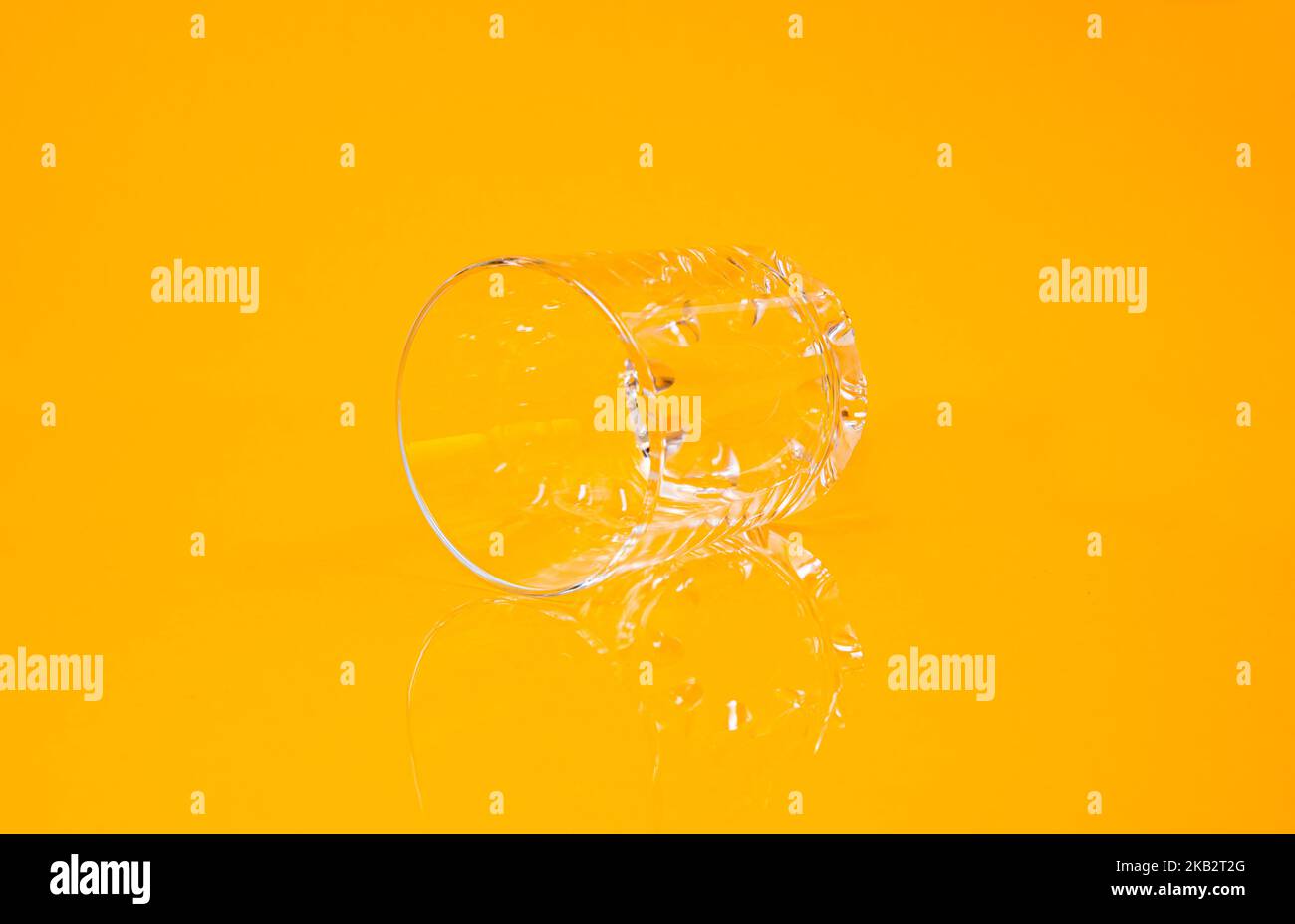empty glass empty jar empty ice bucket on orange background top front view isolated Stock Photo