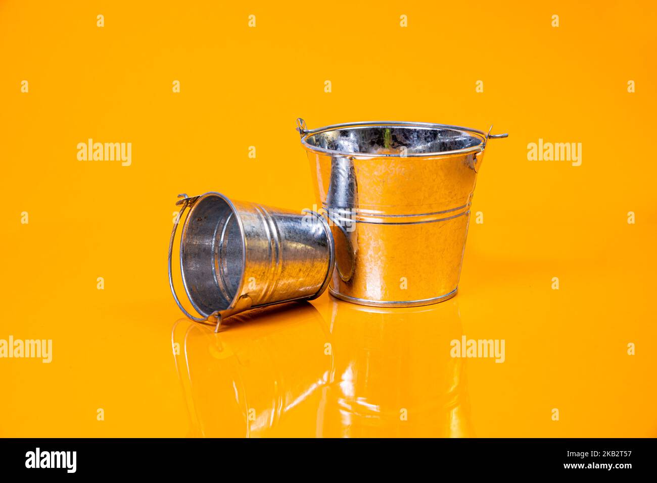 empty glass empty jar empty ice bucket on orange background top front view isolated Stock Photo