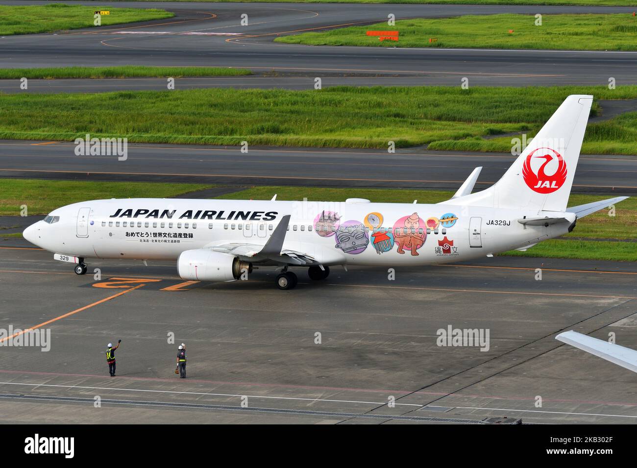 Tokyo, Japan - August 11, 2021: Japan Airlines (JAL) Boeing B737-800 (JA329J) passenger plane 'Jomon Jet' scheme taxiing at Haneda Airport. Stock Photo
