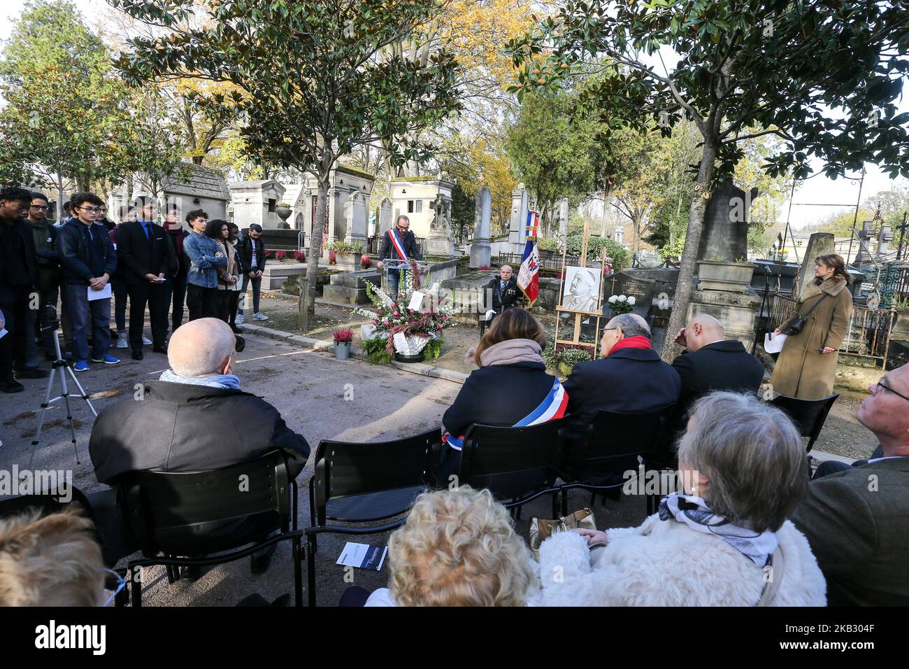 An elected official is speaking near the French poet Guillaume Apollinaire’s portrait during a ceremony held on Novembre 8, 2018, at the grave of the poet at Père Lachaise Cemetery in Paris, during the commemorative events of the 100th anniversary of the end of World War I. Naturalized as a French citizen in 1916, Guillaume Apollinaire fought at the front in Champagne as lieutenant of the 96th Infantry Regiment. Weakened from shrapnel injuries, he died just two days before the Armistice on November 9th from the Spanish flu. (Photo by Michel Stoupak/NurPhoto) Stock Photo