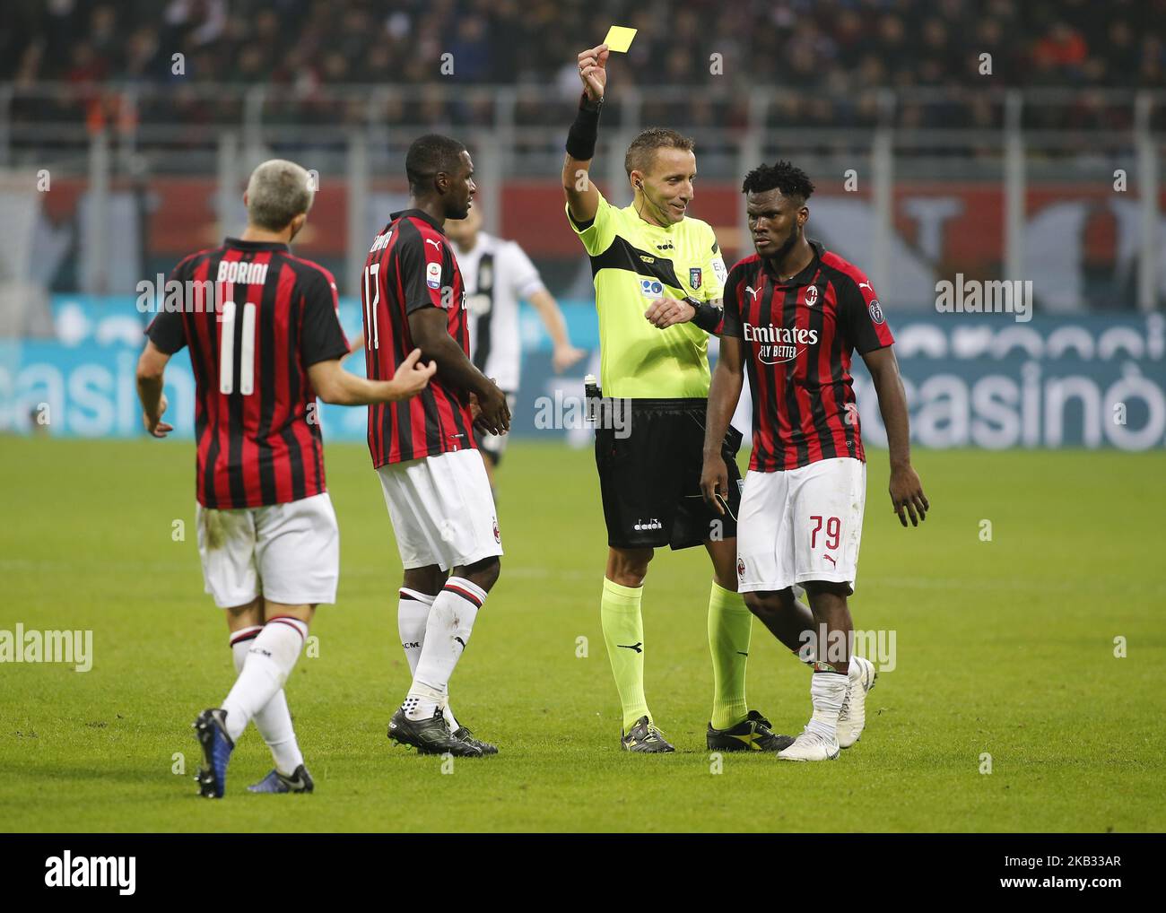 Referee Paolo Mazzoleni gives a red card to Gonzalo Higuain (not in picture) of AC Milan during the Italian Serie A match between AC Milan v Juventus at the San Siro