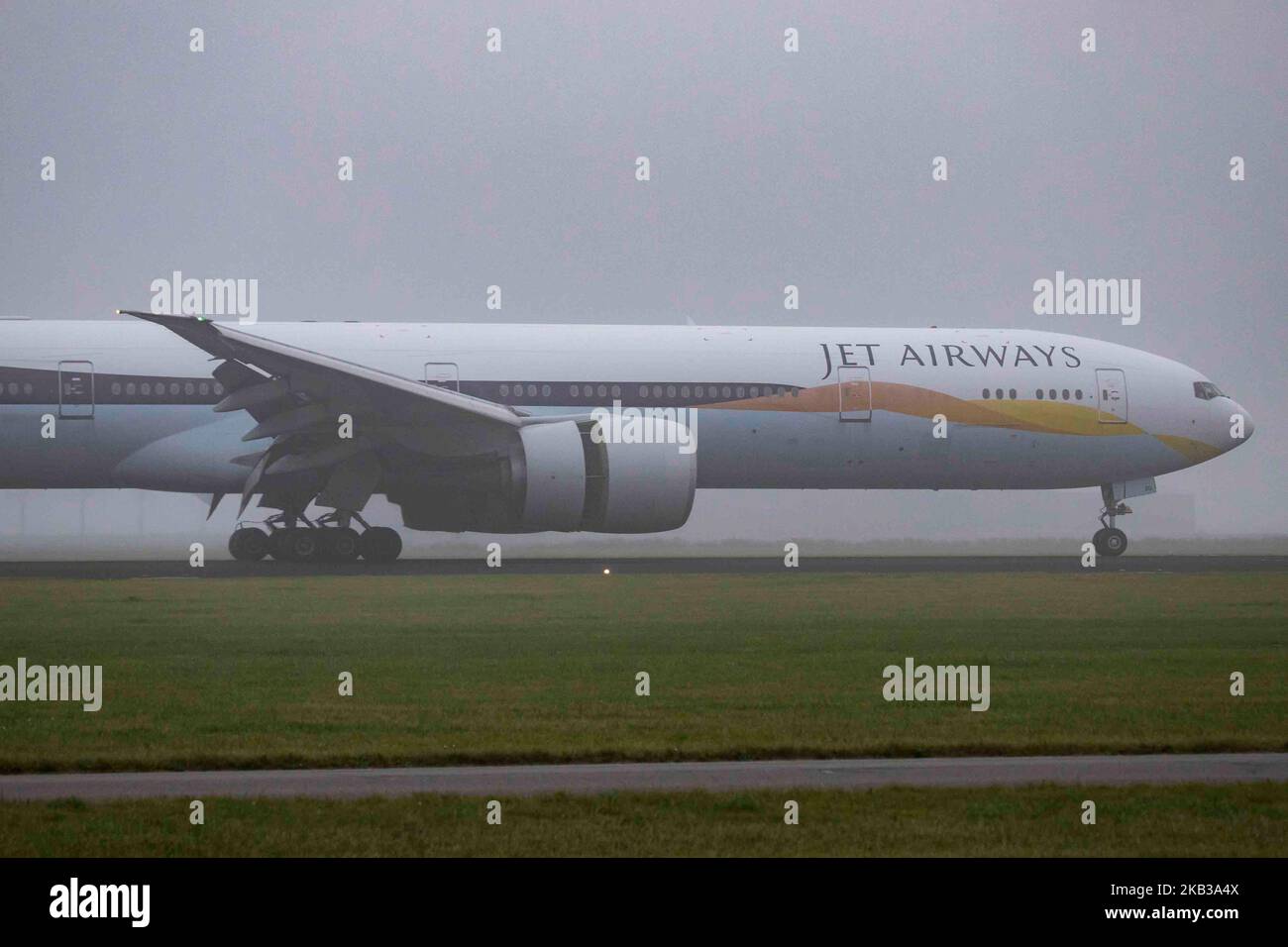 Jet Airways Boeing 777-300 in the mist at Amsterdam Schiphol International Airport. The aircraft registration is VT-JEQ and is a Boeing 777-300 ER or 777-35R(ER). Jet Airways uses Amsterdam as a hub and connects AMS to Bengaluru, Delhi, Mumbai and Toronto Pearson. The airline operates a fleet of 124 aircraft, 10 of them are Boeing 777 and has 230 more on order. The aircraft arrived from Toronto and landed in 18R in fog or the famous Polderbaan runway. (Photo by Nicolas Economou/NurPhoto) Stock Photo