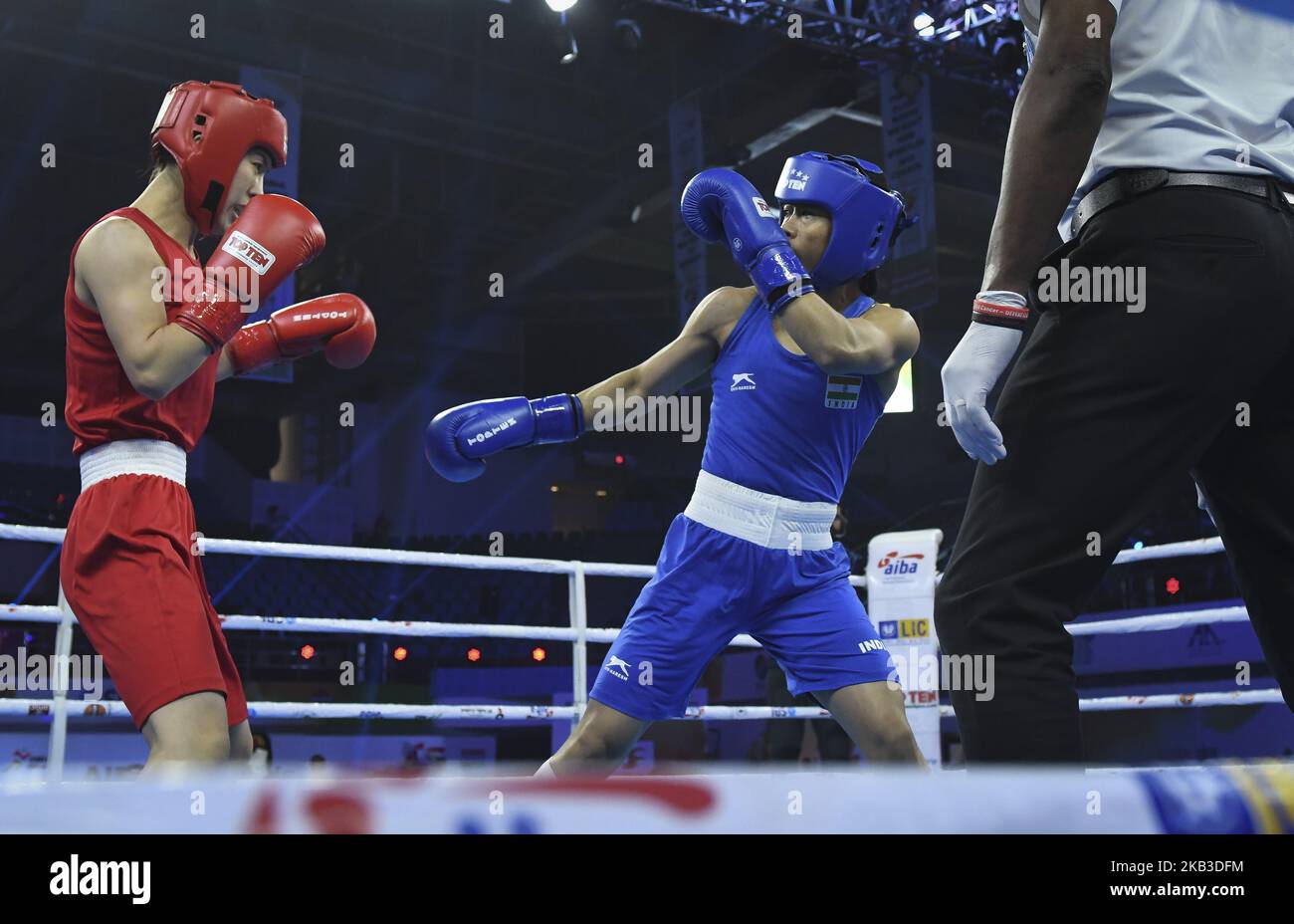 Mary Kom of India (in blue) and Kim Hyang Mi of North Korea (in red) compete during their 45-48 kg category semi-final fight at the 2018 AIBA Women's World Boxing Championships in New Delhi on November 22, 2018. (Photo by Indraneel Chowdhury/NurPhoto) Stock Photo