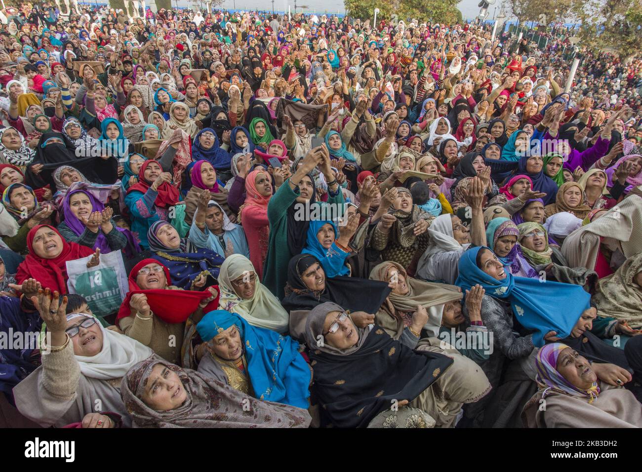Kashmiri Muslim women devotees look towards a cleric (not seen in the ...