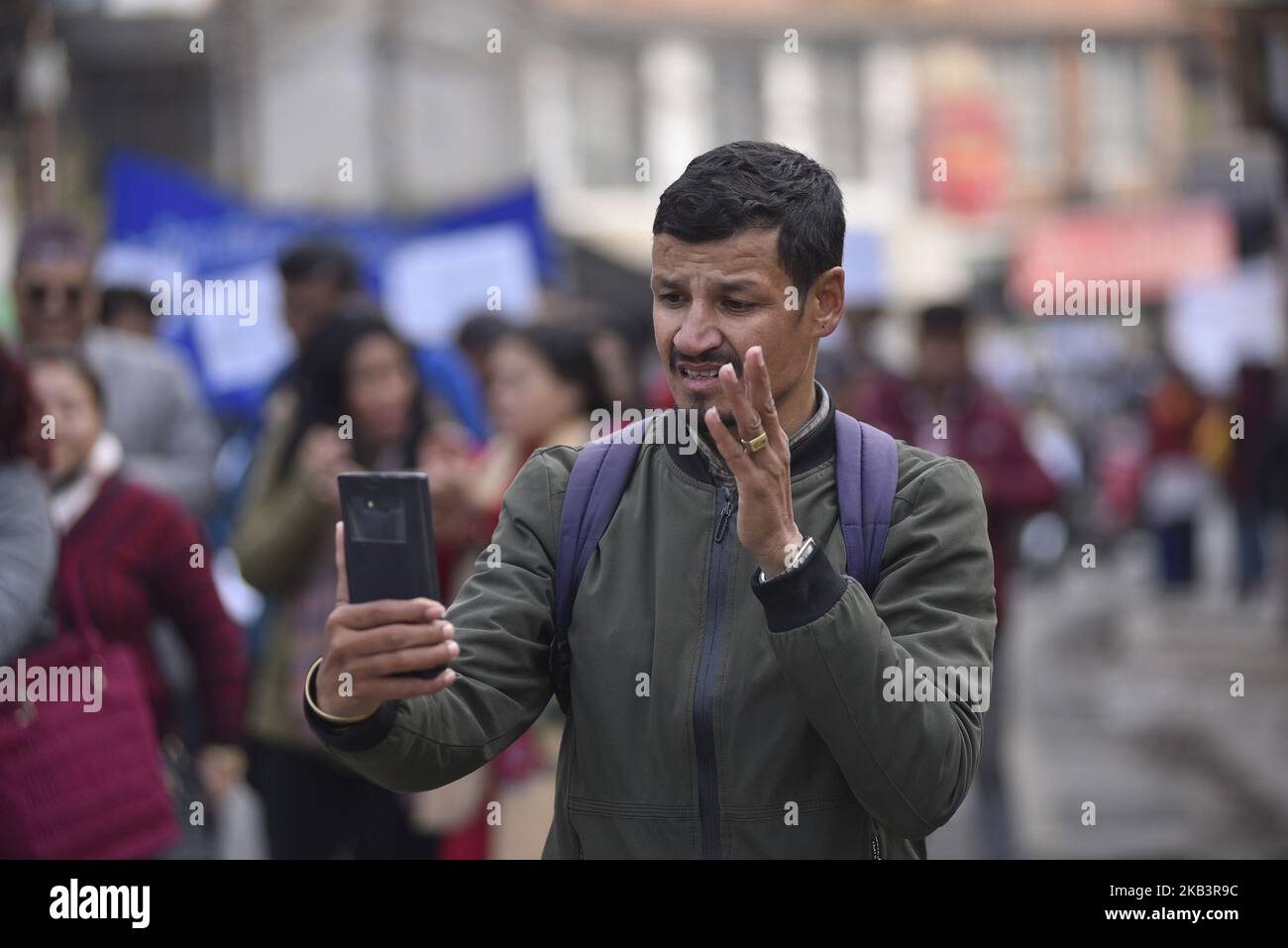 A Nepalese deaf man communicate in a mobile phone using the signs language in a rally during 27th International Day of Persons with Disabilities in Kathmandu, Nepal on Monday, December 03, 2018. The 27th World Disability Day focuses on 'Empowering persons with disabilities and ensuring inclusiveness and equality'. (Photo by Narayan Maharjan/NurPhoto) Stock Photo