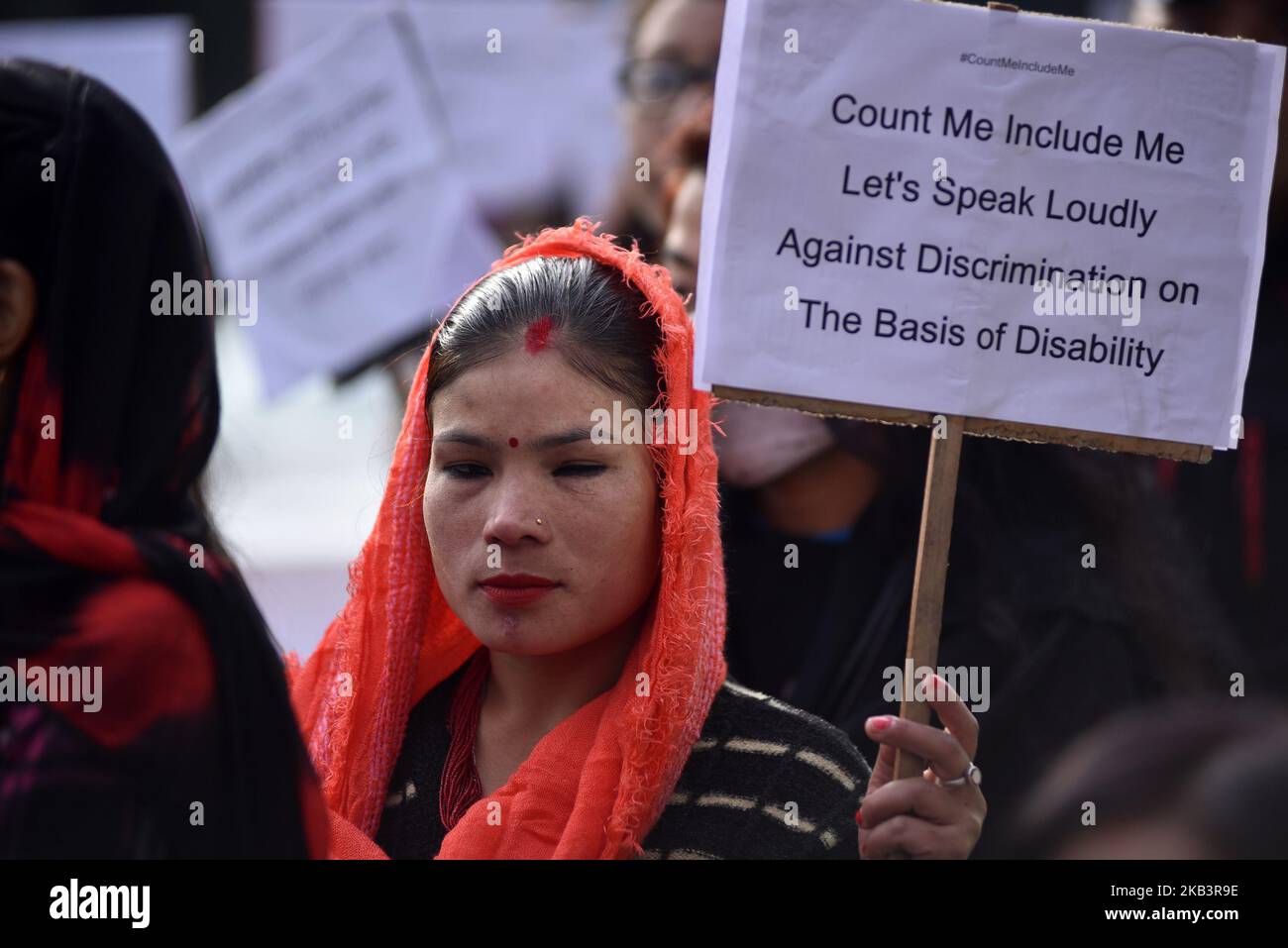 A visually impaired Nepalese woman holds placard in a rally during 27th International Day of Persons with Disabilities in Kathmandu, Nepal on Monday, December 03, 2018. The 27th World Disability Day focuses on 'Empowering persons with disabilities and ensuring inclusiveness and equality'. (Photo by Narayan Maharjan/NurPhoto) Stock Photo