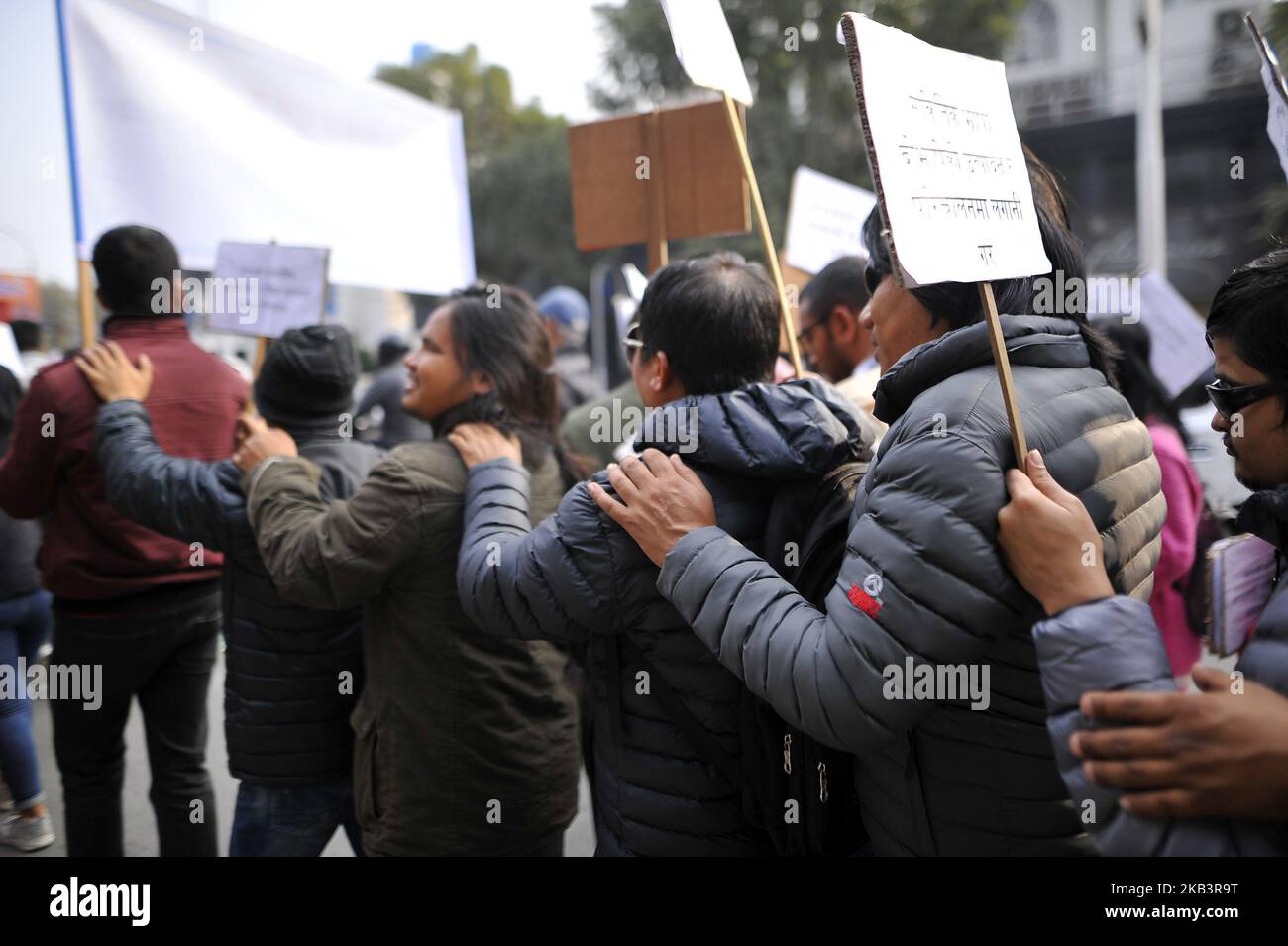 Visually impaired Nepalese people hold each others shoulder in a rally during 27th International Day of Persons with Disabilities in Kathmandu, Nepal on Monday, December 03, 2018. The 27th World Disability Day focuses on 'Empowering persons with disabilities and ensuring inclusiveness and equality'. (Photo by Narayan Maharjan/NurPhoto) Stock Photo