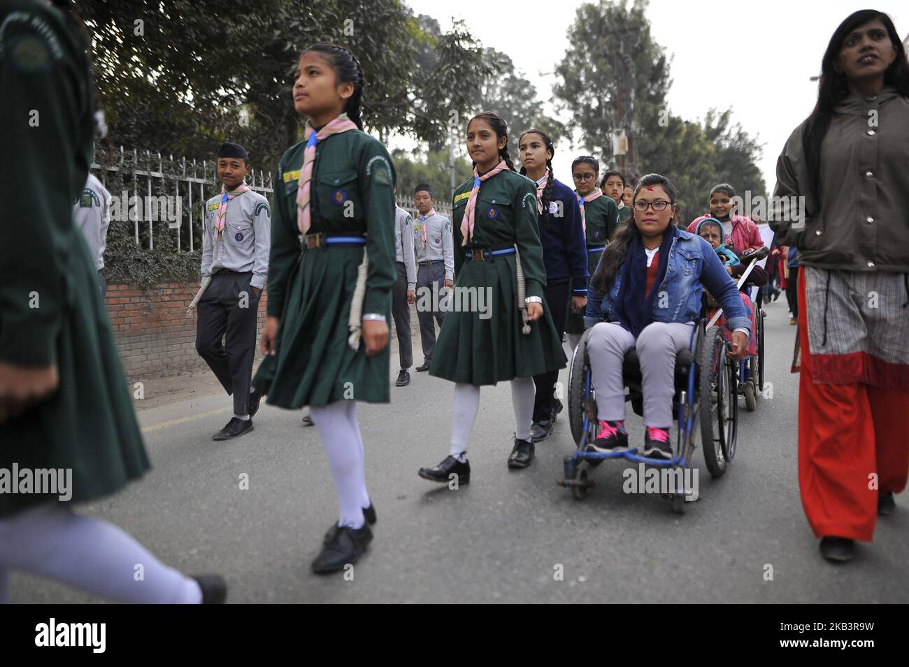 A Nepalese girl on wheelchairs take part in a rally during 27th International Day of Persons with Disabilities in Kathmandu, Nepal on Monday, December 03, 2018. The 27th World Disability Day focuses on 'Empowering persons with disabilities and ensuring inclusiveness and equality'. (Photo by Narayan Maharjan/NurPhoto) Stock Photo