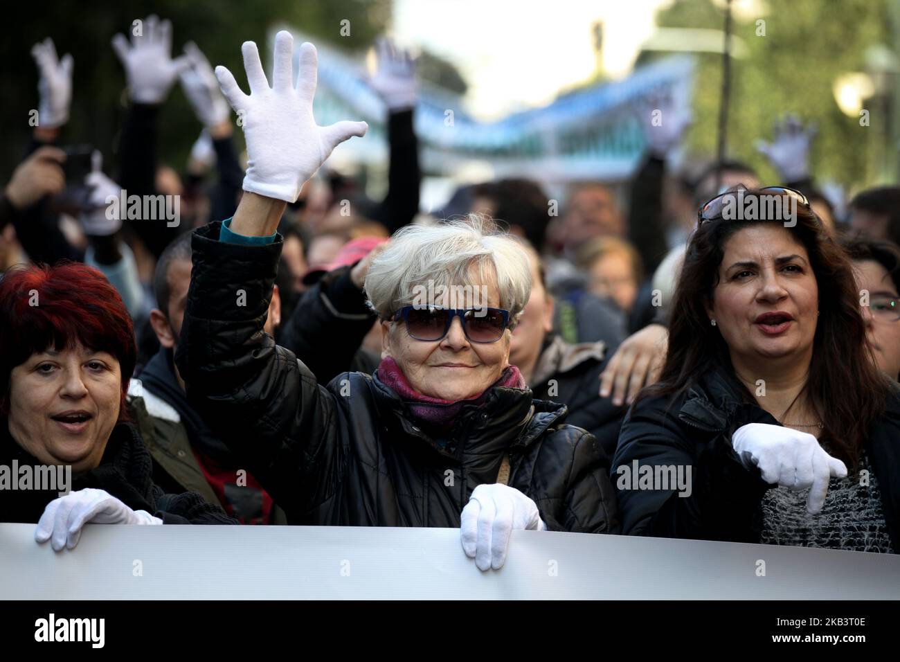 Protesters wear white gloves and use sign language during a protest for disabled rights on the occasion of the International Day for Persons with Disabilities in Athens, Greece on December 3, 2018. Protesters demand wage and social welfare since they have been eliminated by years of austerity measures. (Photo by Giorgos Georgiou/NurPhoto) Stock Photo